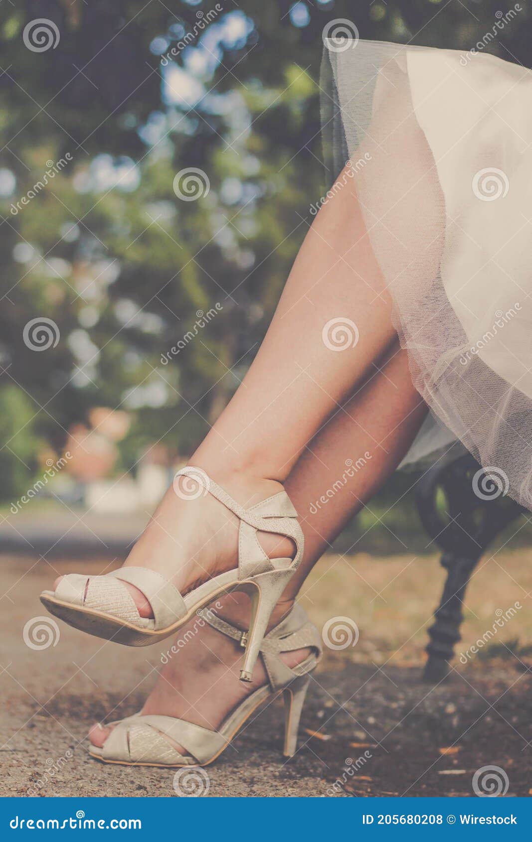 Novia Con Vestido De Blanco Y Con Sandalias De Tacón Alto En Un Banco De Un Parque Foto de archivo - Imagen de sandalia, boda: 205680208