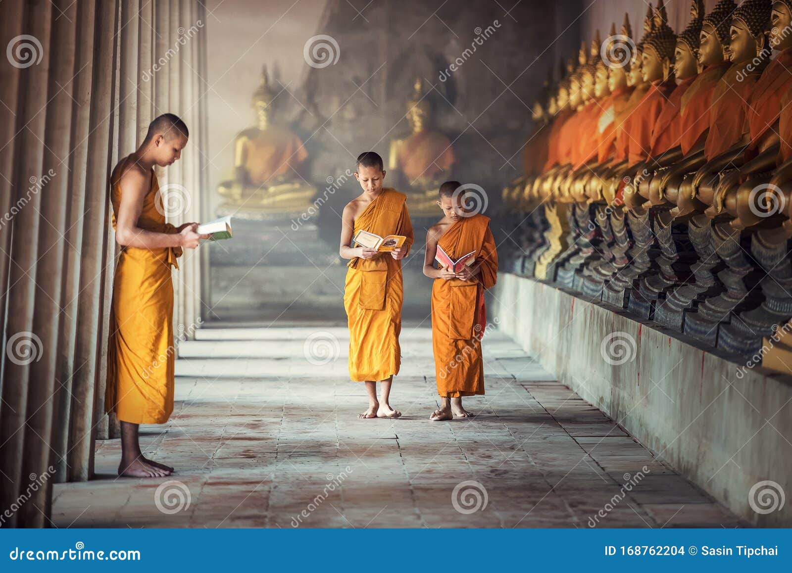 novice monks reading book inside monastery at ayutthaya province