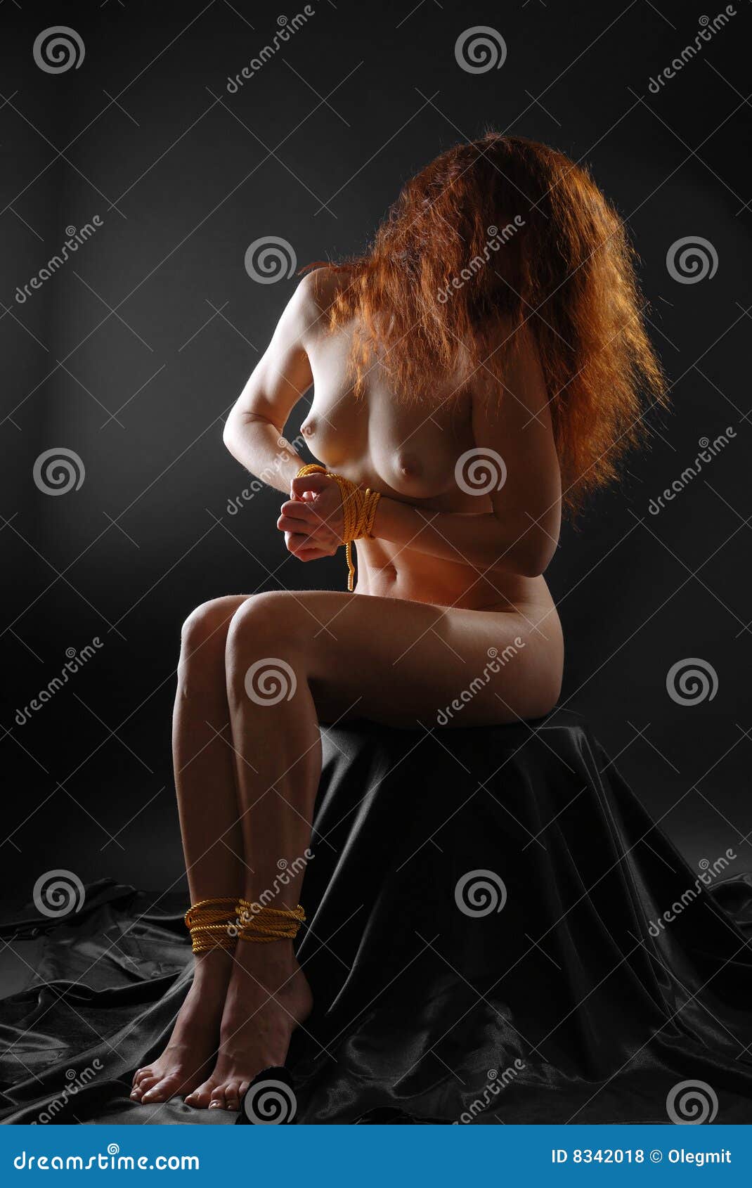 Nude Girl Tied Hand and Foot in Dark Stock Photo pic