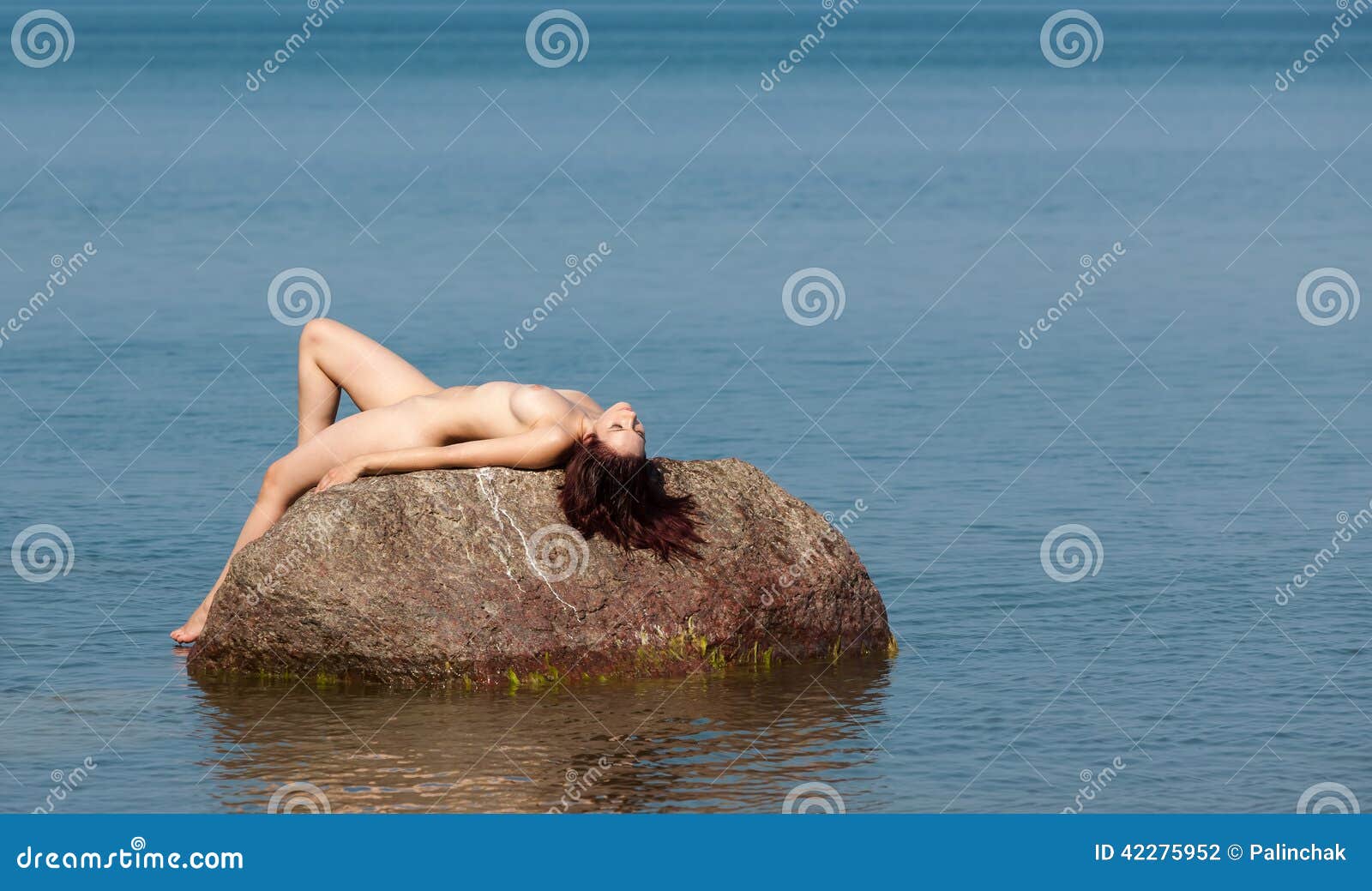 Nude Woman Lying on a Rock in the Sea Stock Photo - Image of