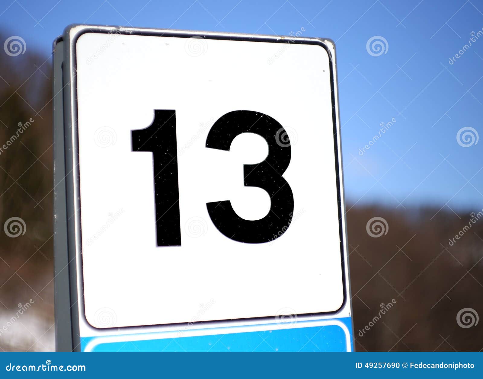 number 13 in a road sign in mountain