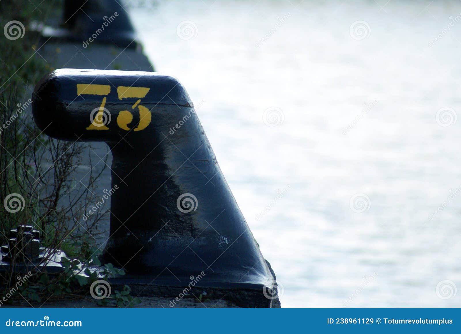 number seventy three 73 in yellow colour on black iron noray