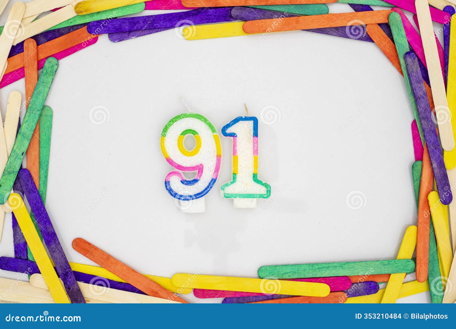 number 91  birthday candles in a colorful popsicle sticks frame border on white background
