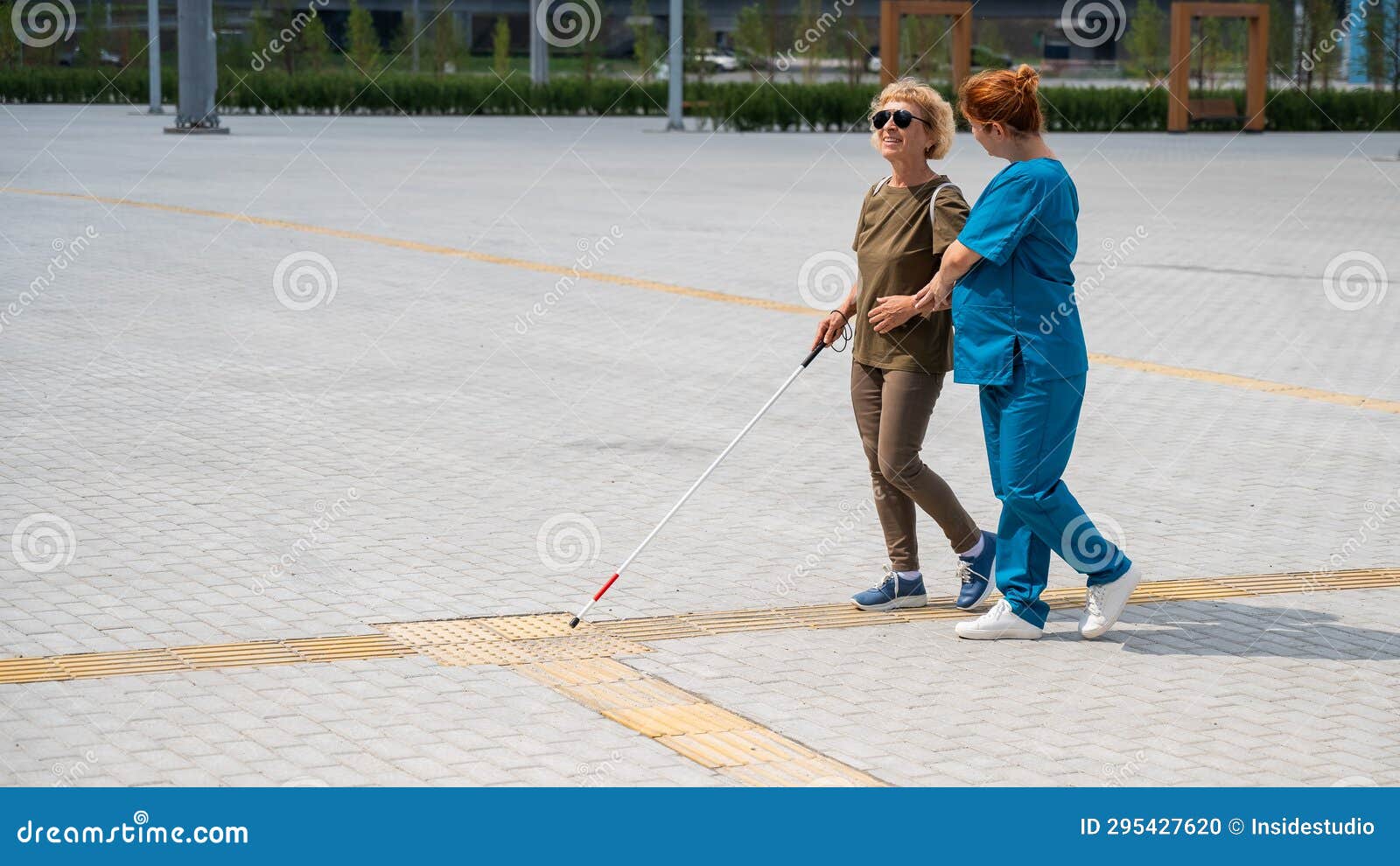 A Nurse an Elderly Blind Woman on a Walk. Stock Photo