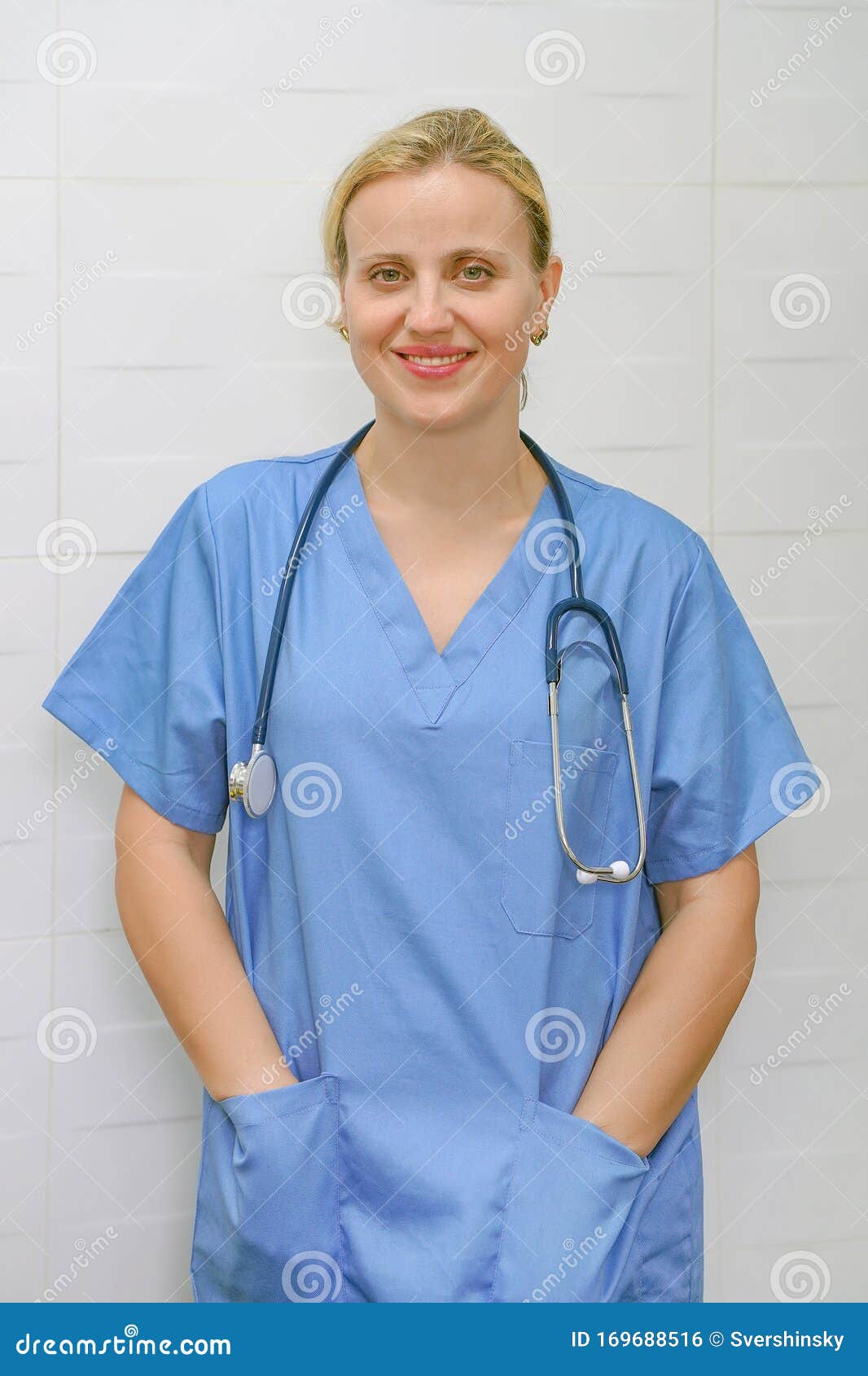 A Nurse with Blond Hair and a Stethoscope in Uniform is Smiling at the ...