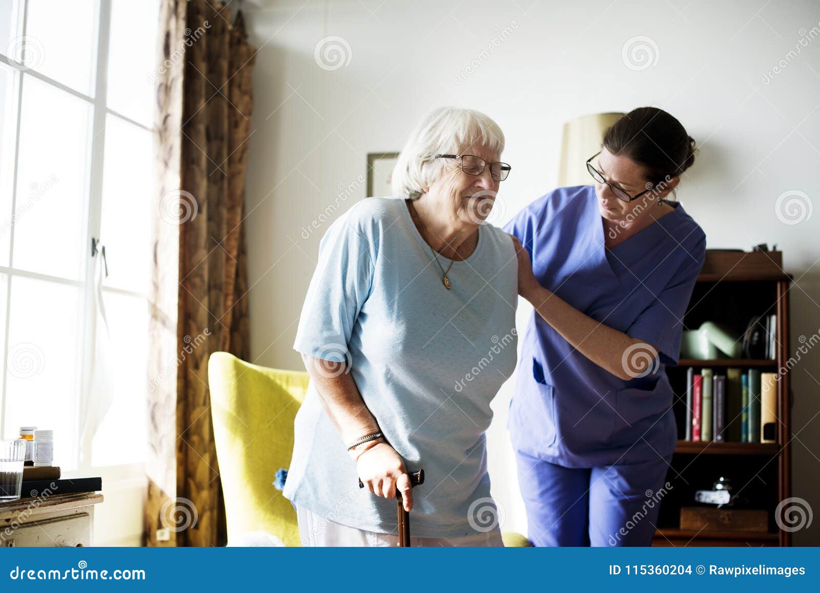 nurse helping senior woman to stand