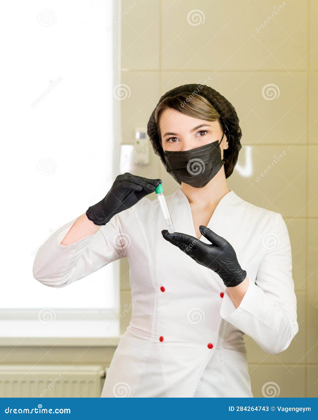 nurse holding test tubes