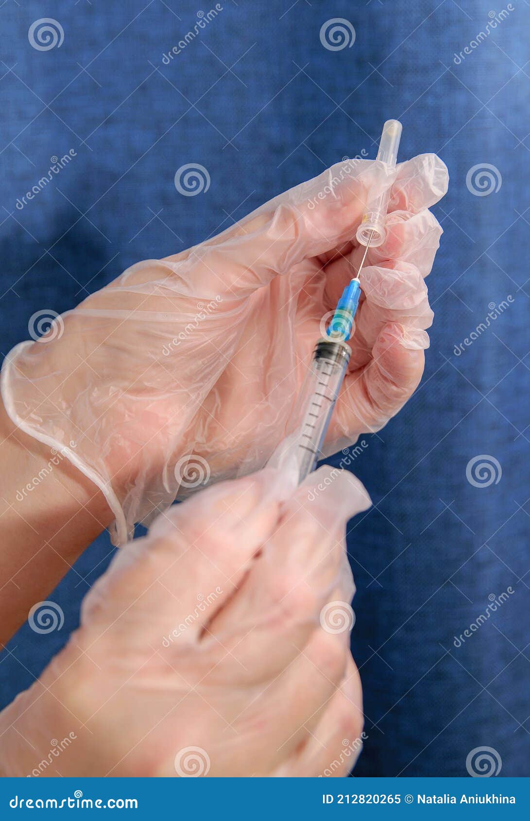 Nurse Holds Syringe for Injection and Removes Cap from Syringe Stock