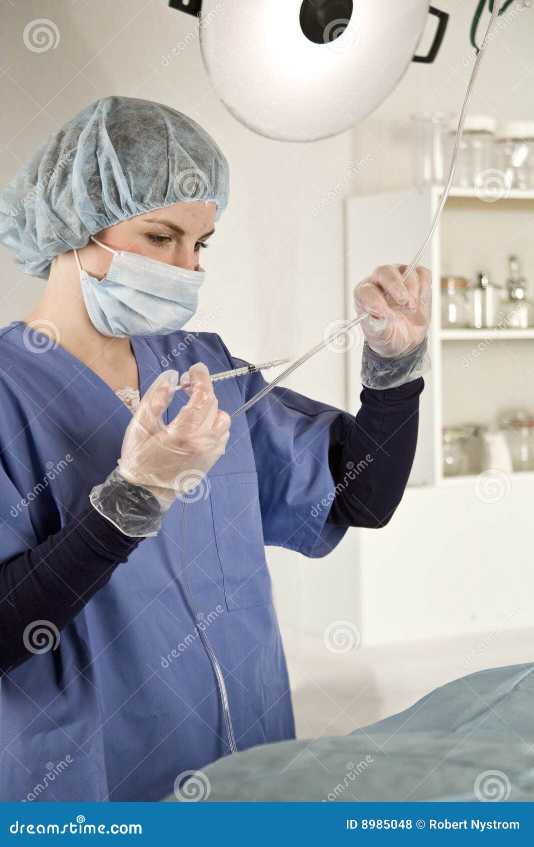 nurse injecting with syringe into iv tube