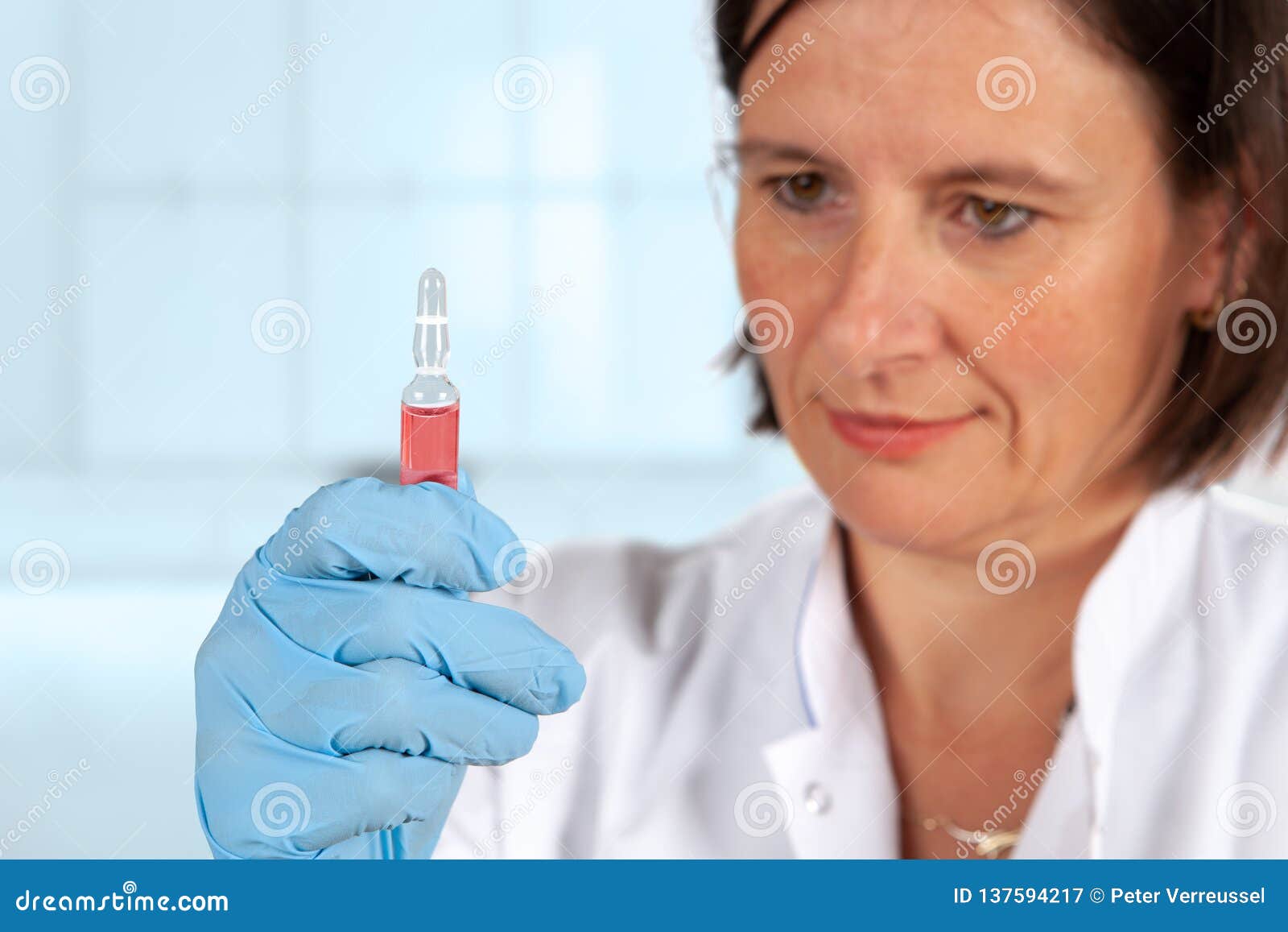 Nurse looking at ampoule stock image. Image of clinical 137594217