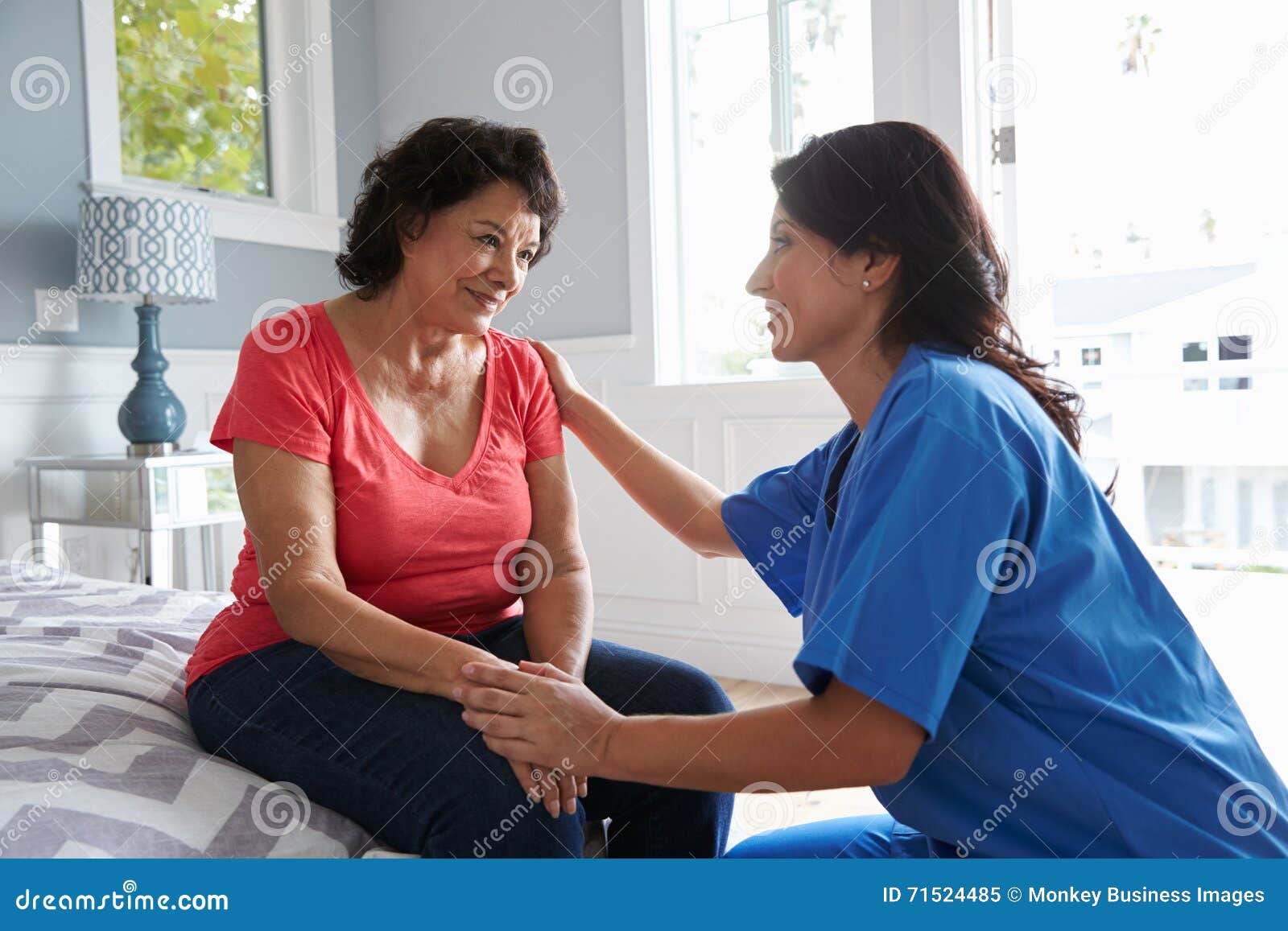 nurse making home visit to senior hispanic woman