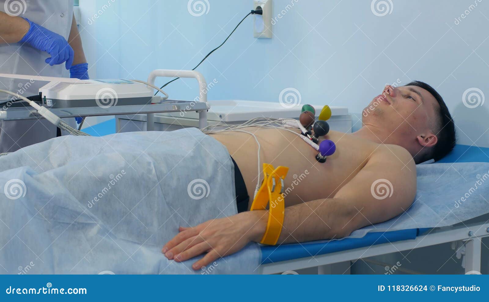 nurse performing ecg on a male patient