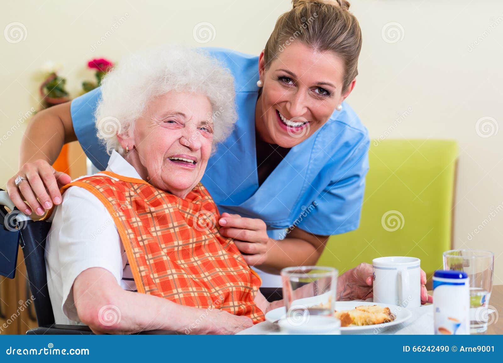 nurse with senior woman helping with meal
