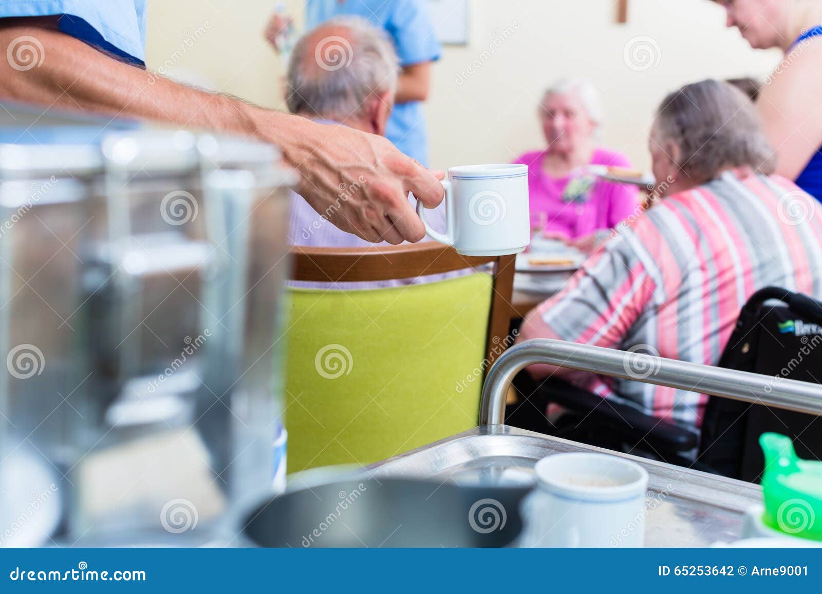 nurse serving food in nursing home