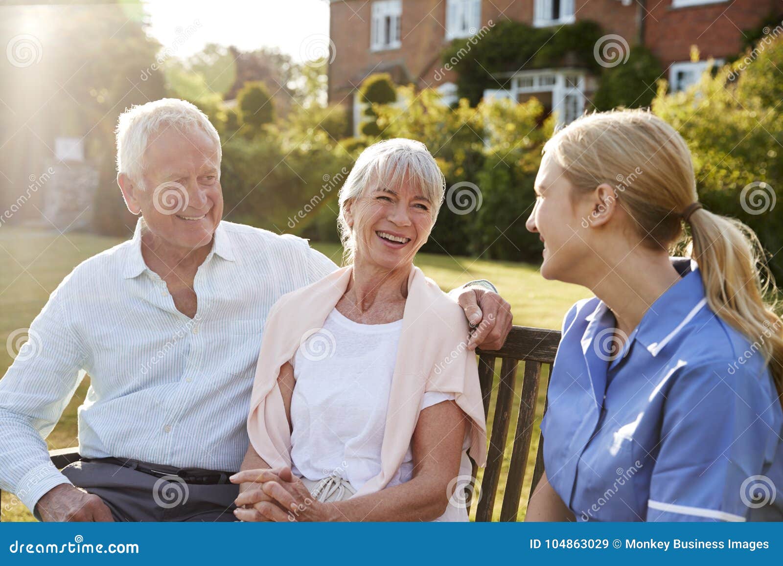 nurse talking to senior couple in residential care home