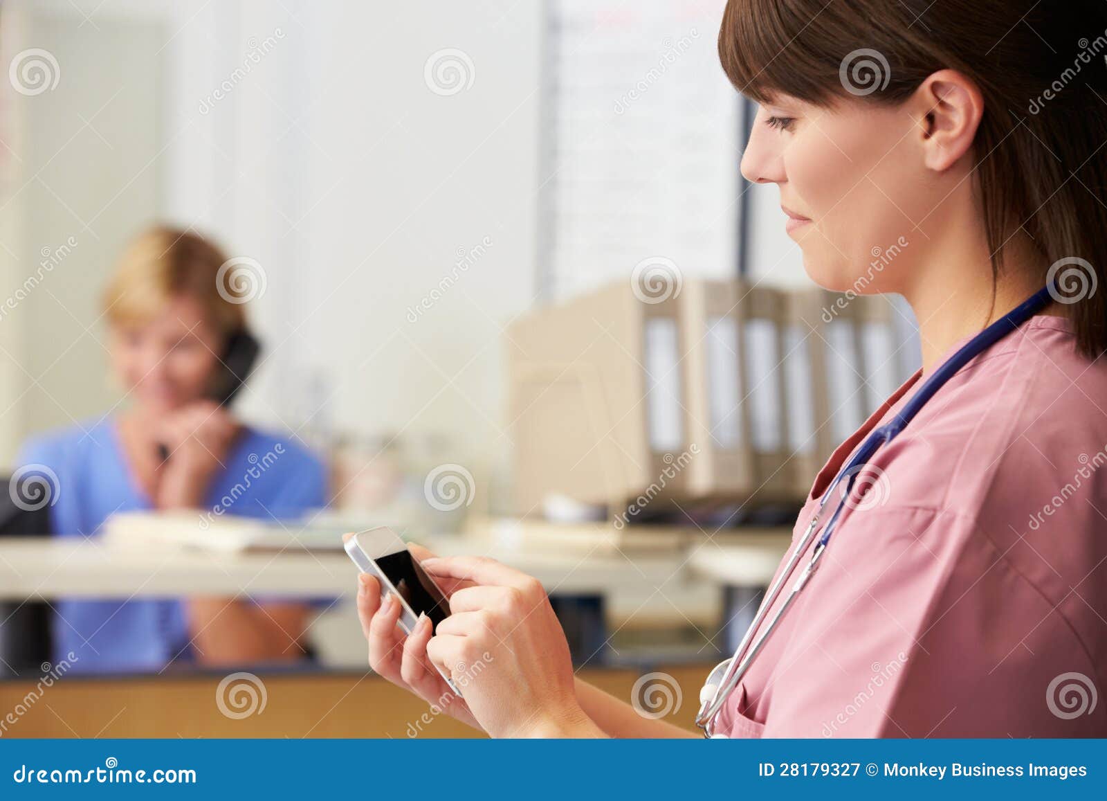 nurse using mobile phone nurses station 28179327