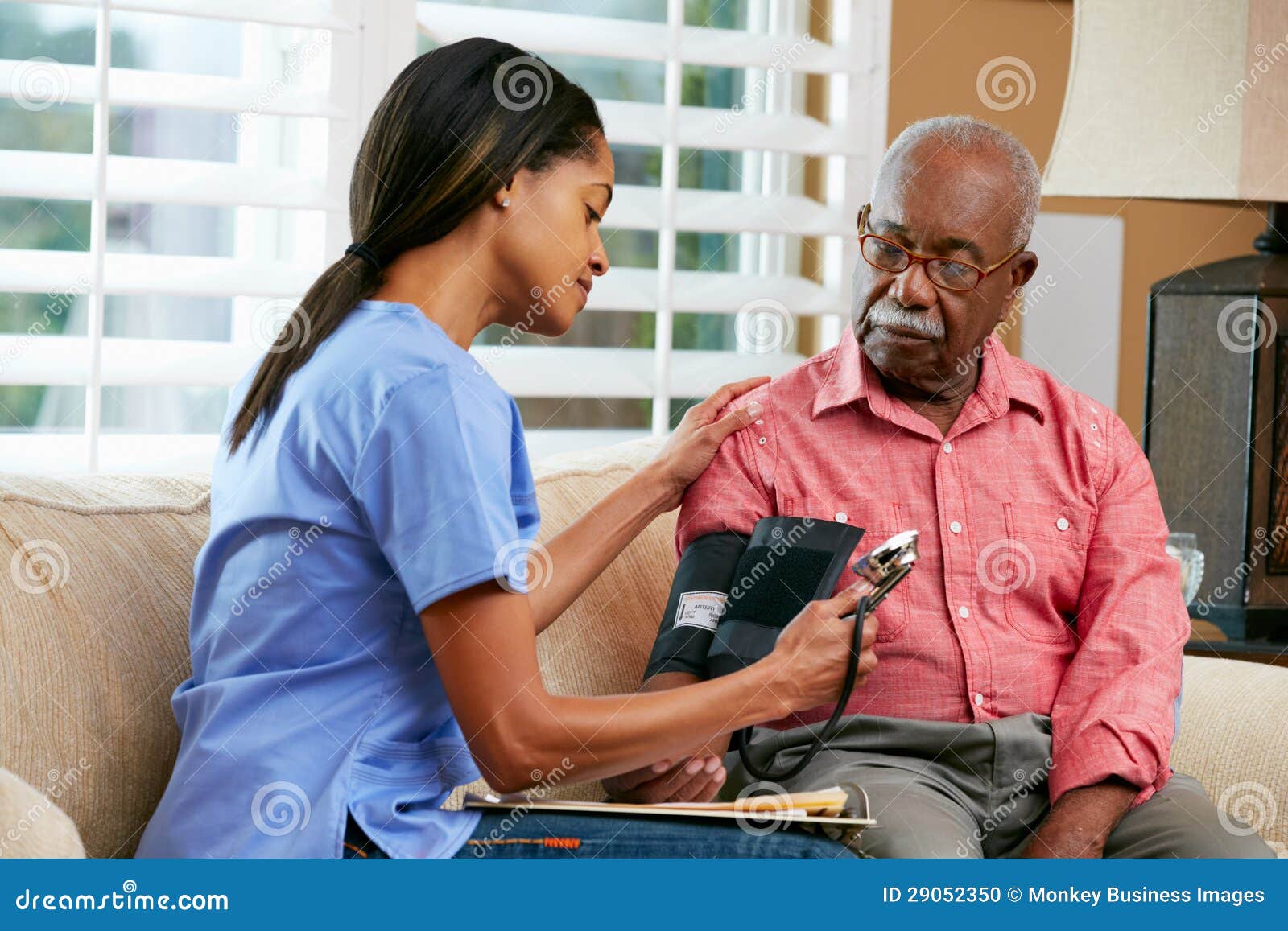 nurse visiting senior male patient at home