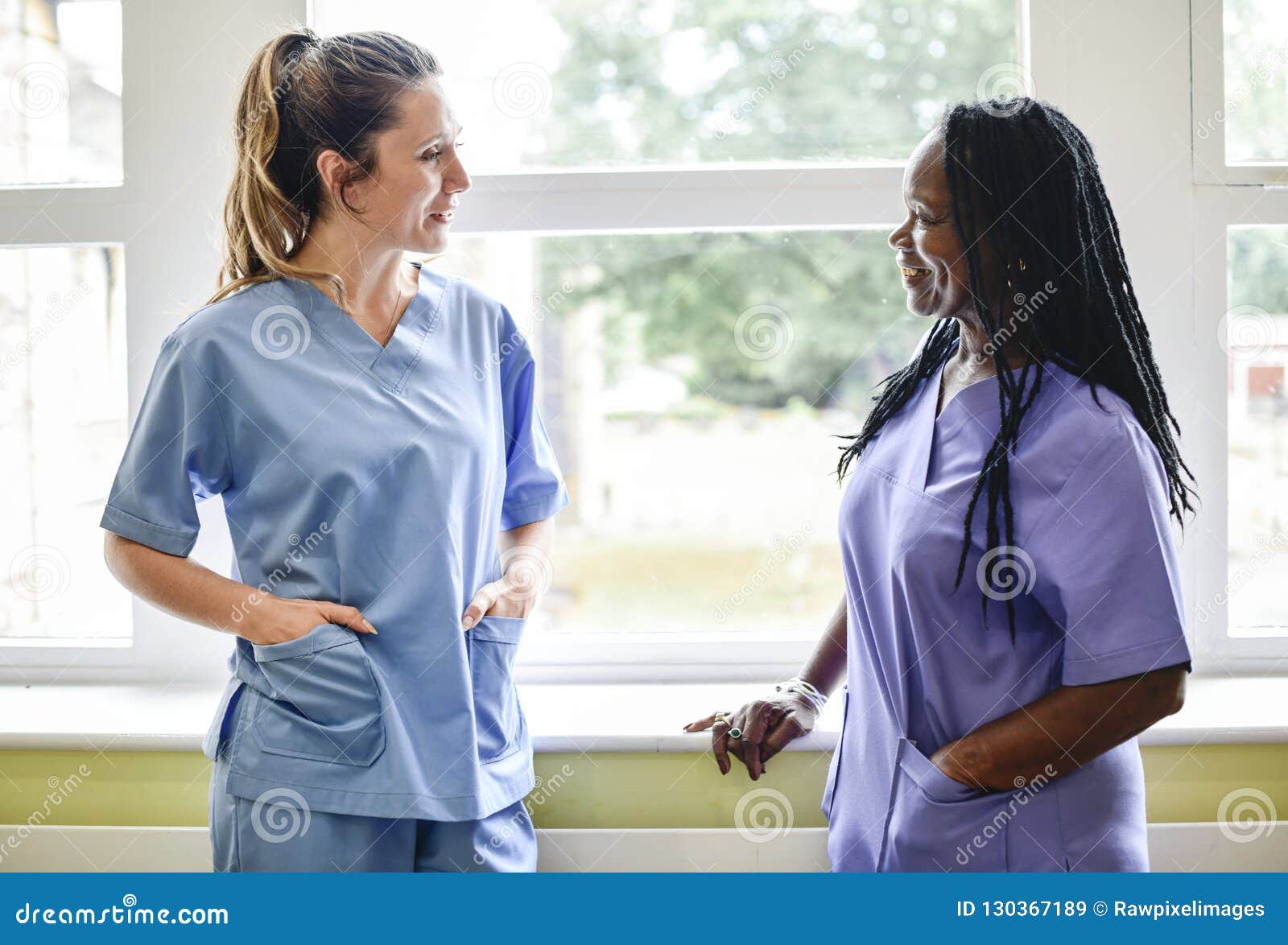 nurses having a conversation in the hospital hallway