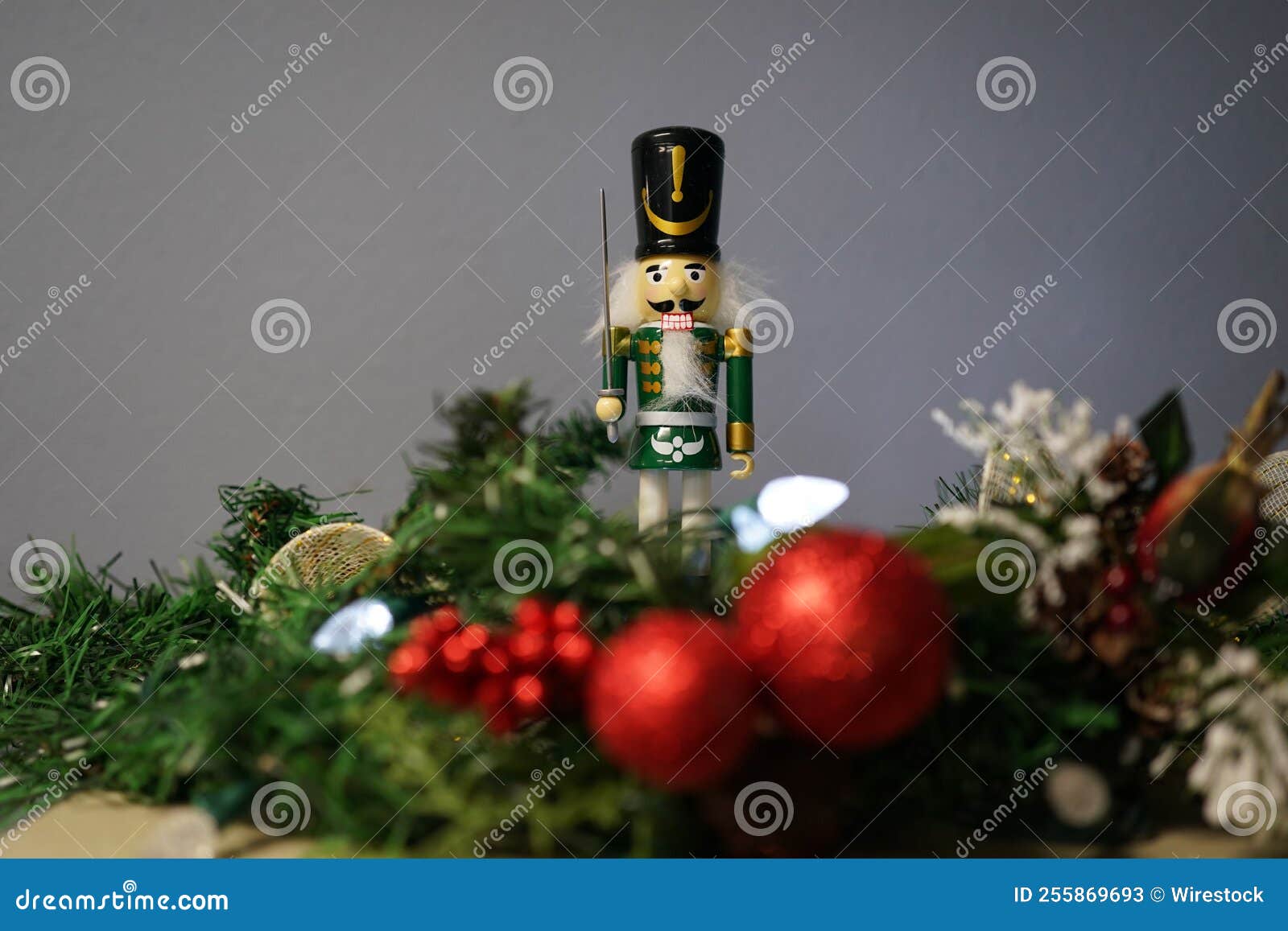 Nutcracker Toy on Top of the Christmas Tree with Colorful Balls Stock