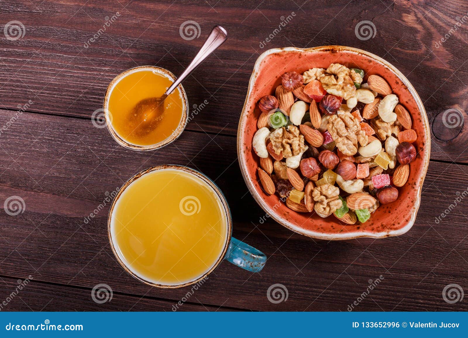 Nuts Mix in a Bowl, Cup of Tea and Honey on Dark Wooden Background ...