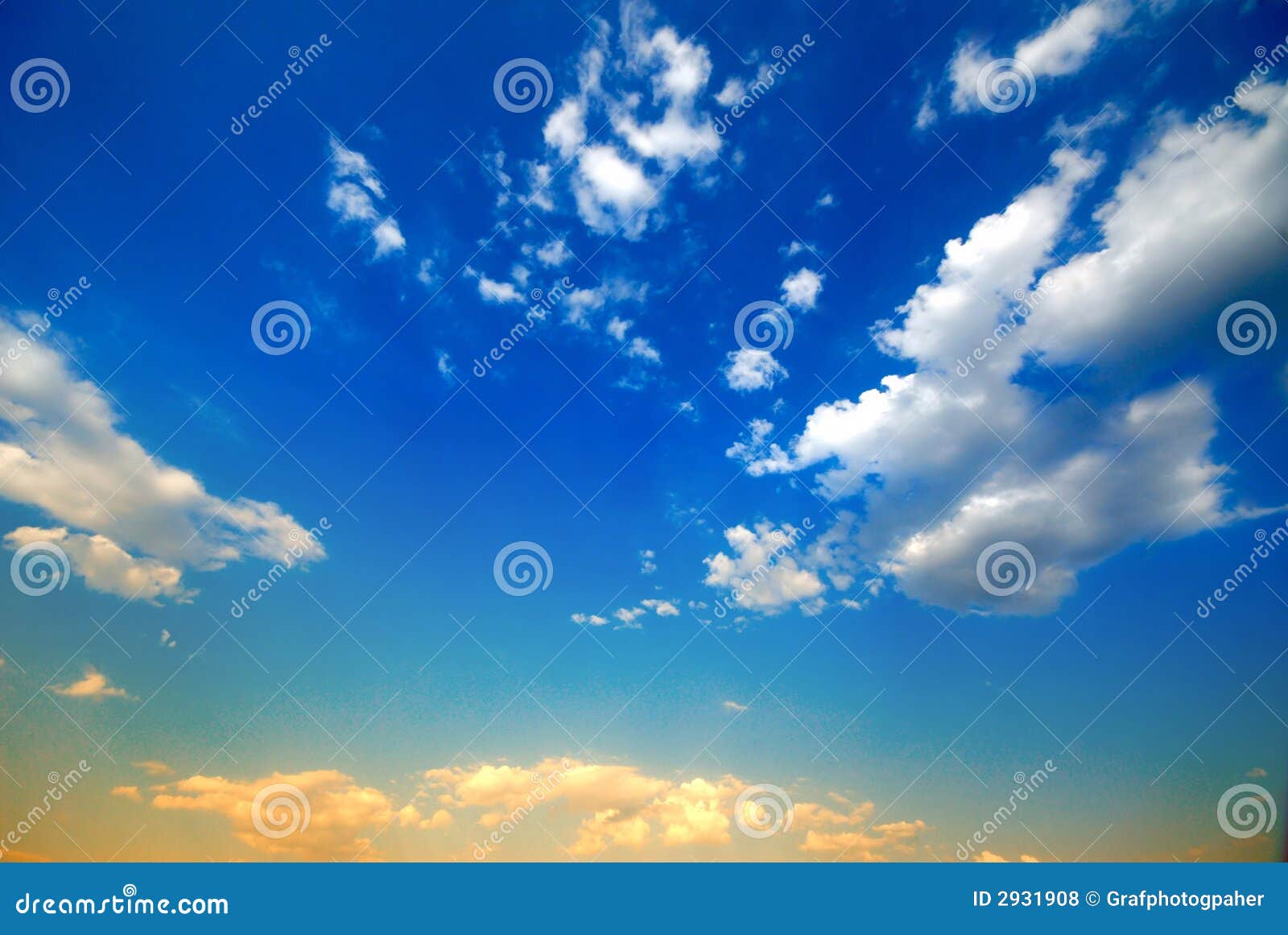As nuvens brancas no fundo do céu azul são cobertas por feixes do sol de vinda