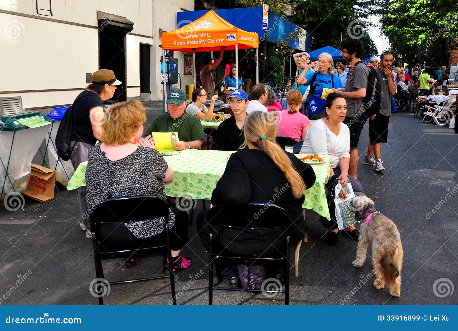 NYC: People Eating at a Block Fair. People sitting at outdoor tables relaxing and eating an the annual West 75th Street Block Association street fair in NYC.