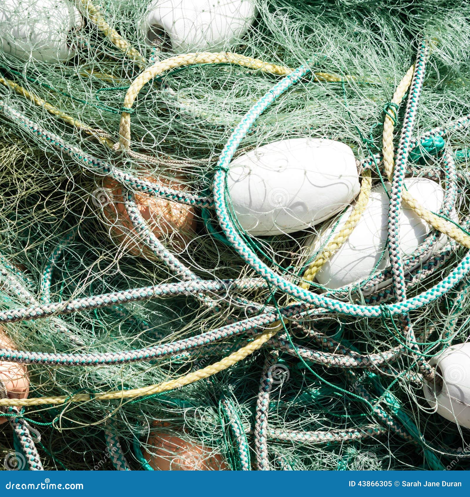 Heap Of Fishing Nets With Ropes And Floats Commercial Fishing Net Tangled With Ropes And Floats