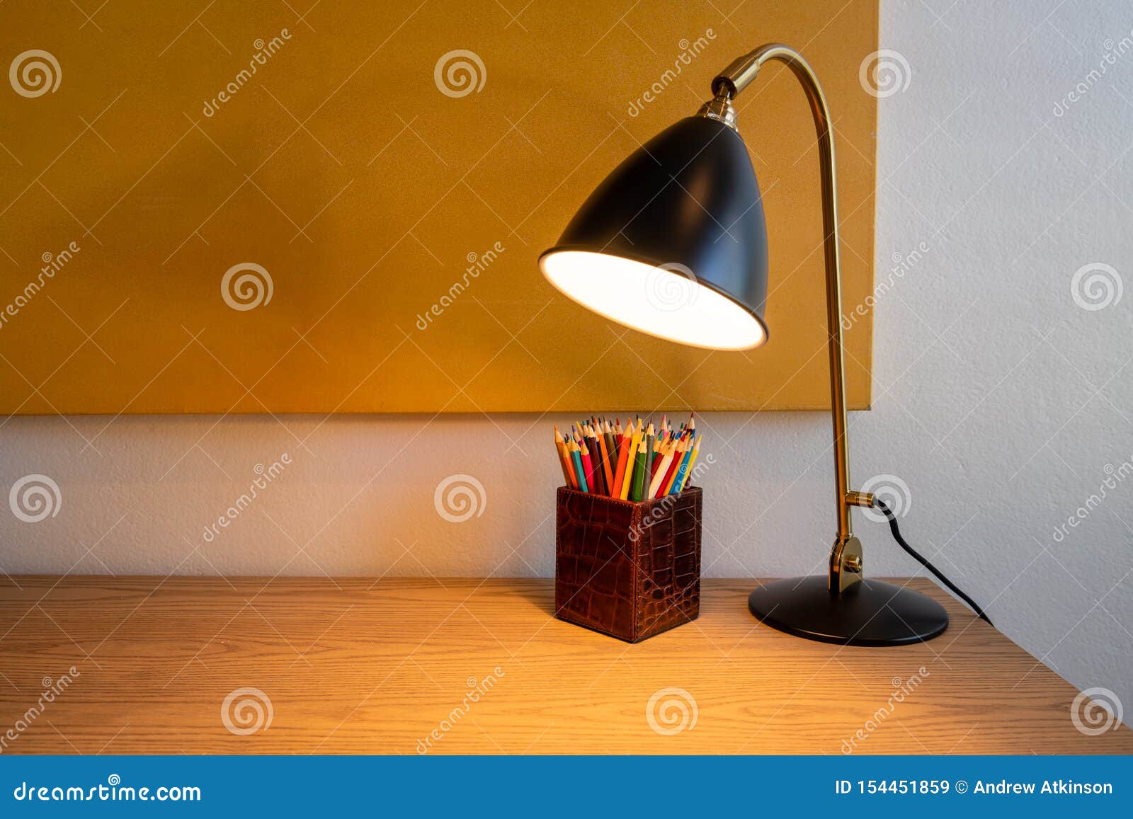 Oak Colored Desk With Lamp And Box Of Colored Pencils Stock Image