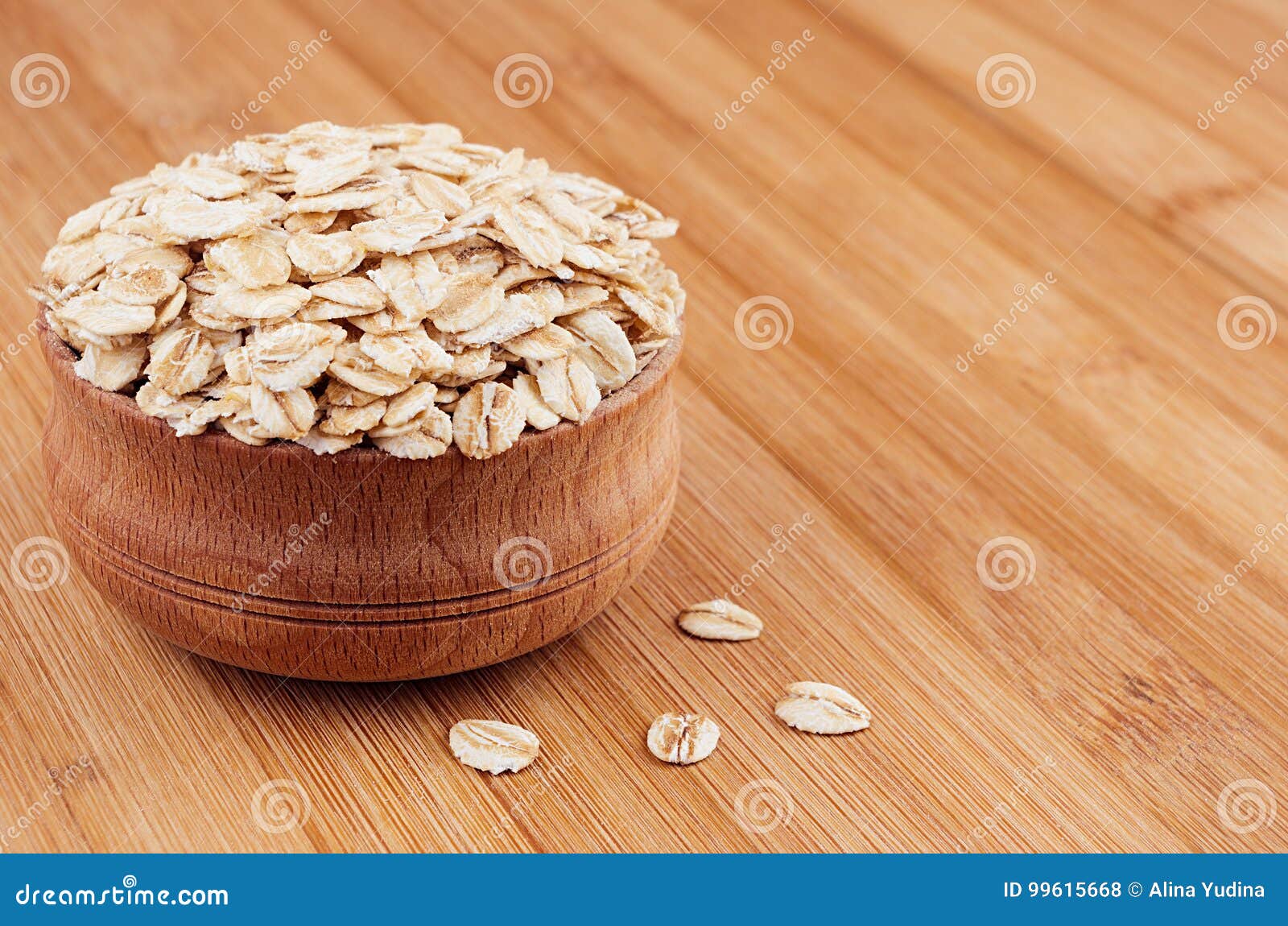 Oat-flake in Wooden Bowl on Brown Bamboo Board, Closeup. Healthy ...