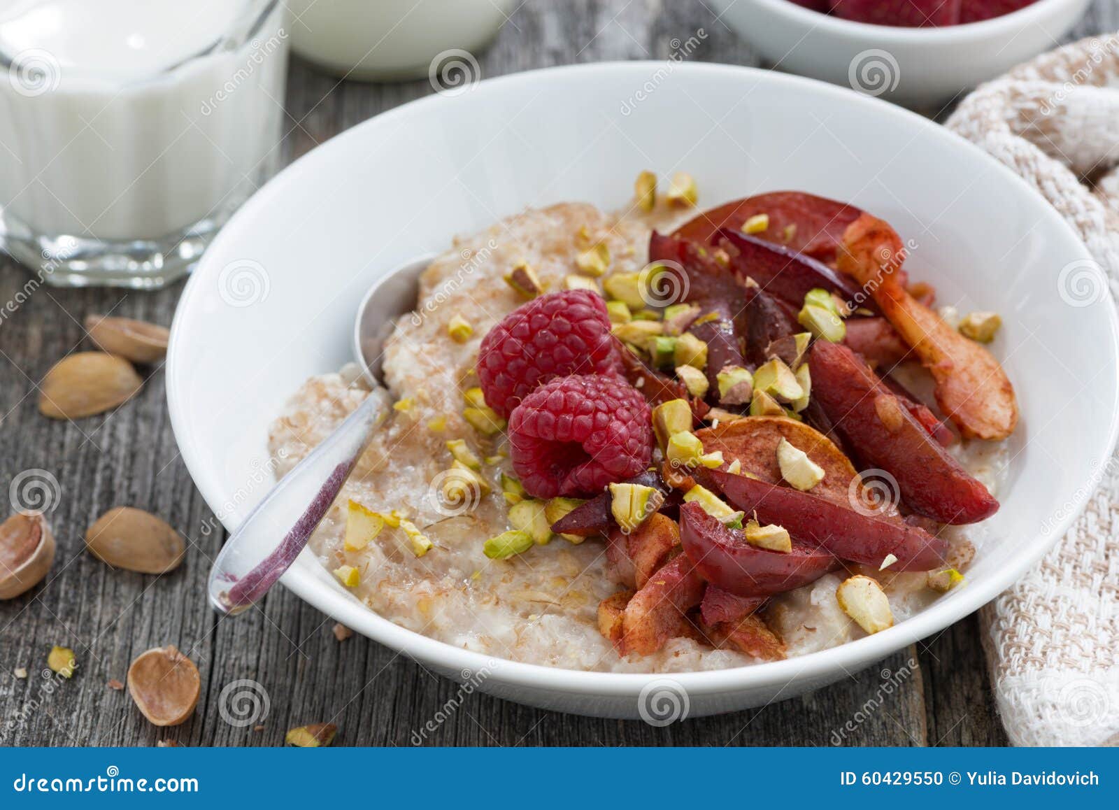 Oatmeal with Baked Fruit and Pistachios for Breakfast, Closeup Stock