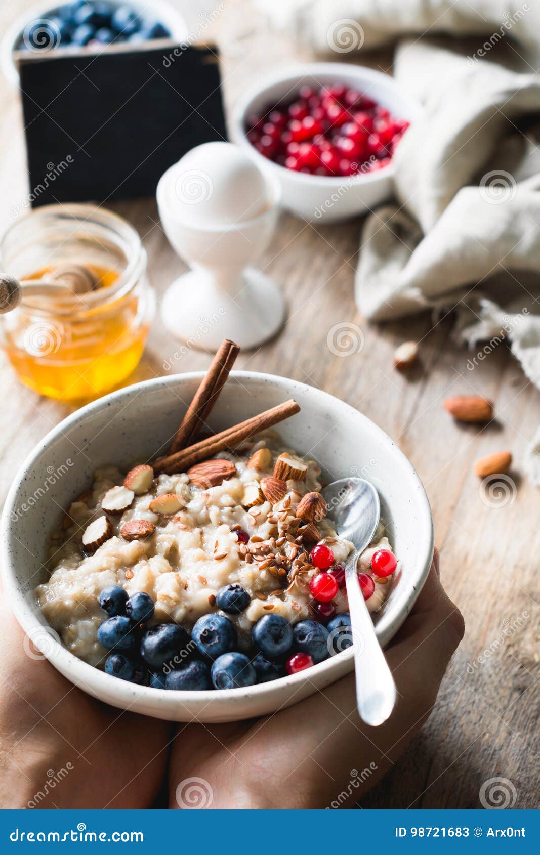 oatmeal porridge bowl with superfoods in hands