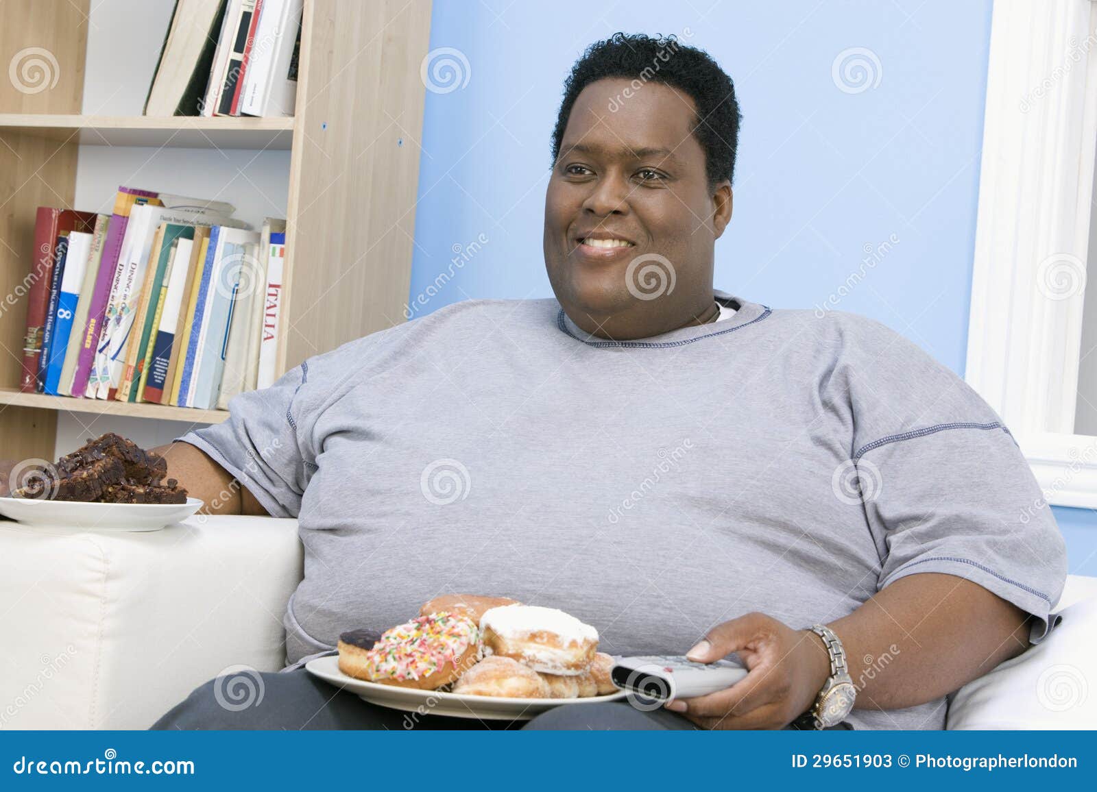 Obese Man Sitting on Sofa stock image. Image of leisure 29651903