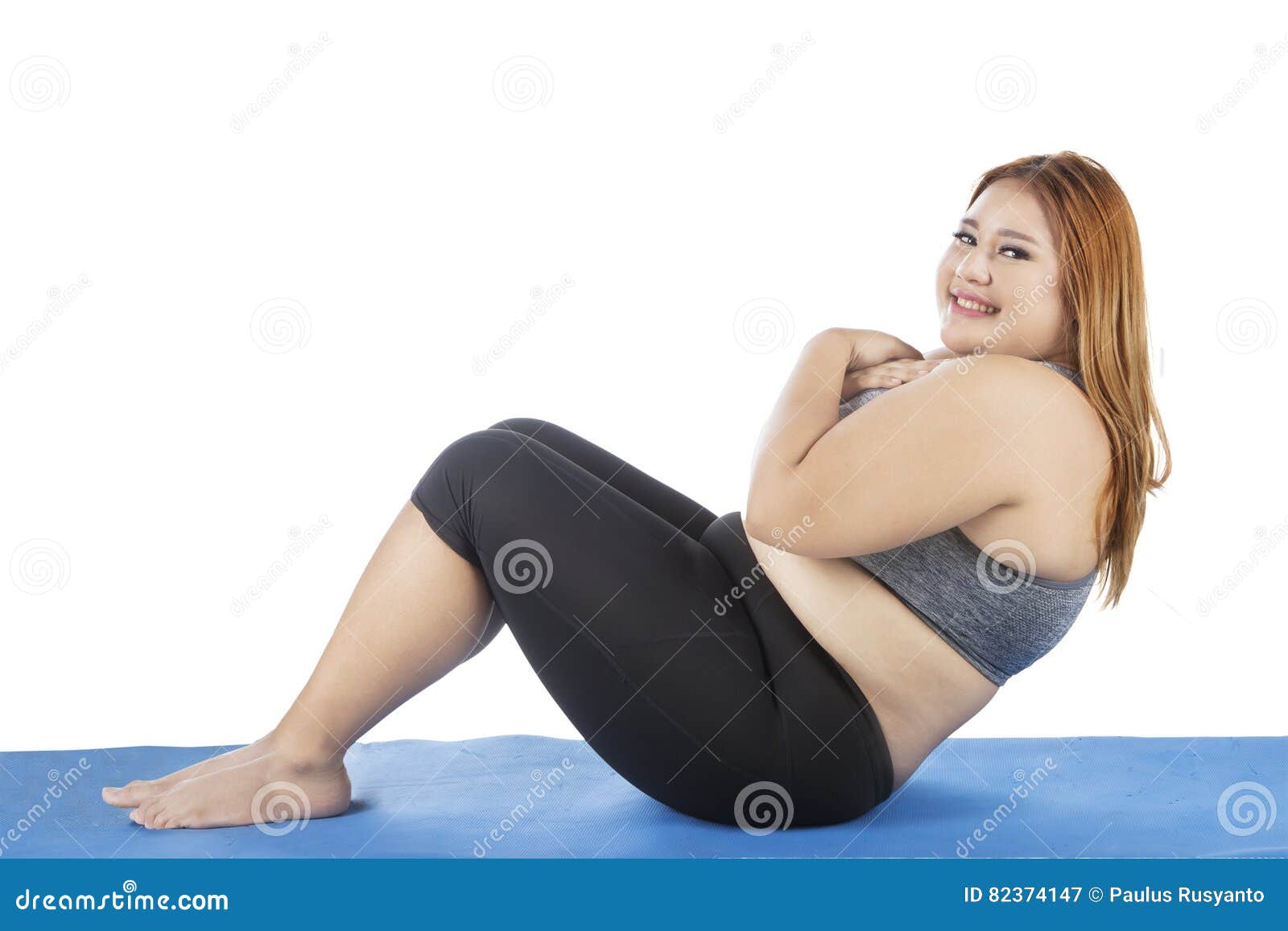 Fitness Concept. Portrait of happy black plus size woman holding