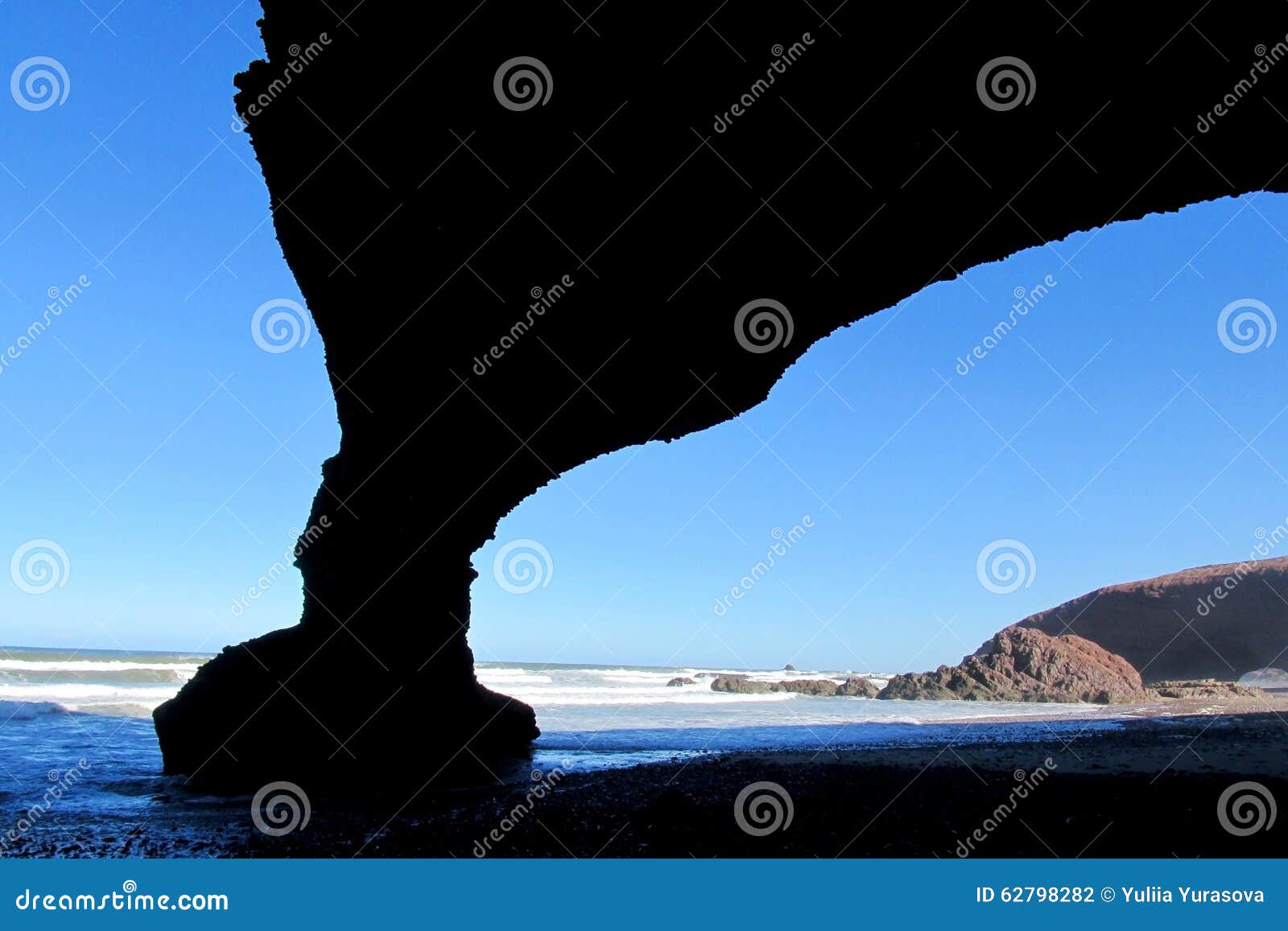 ocean beach stone arch silhouette