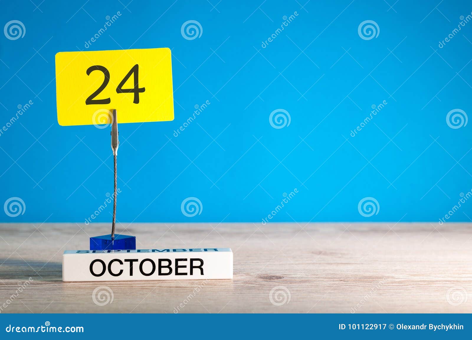 october 24th. day 24 of october month, calendar on workplace with blue background. autumn time. empty space for text