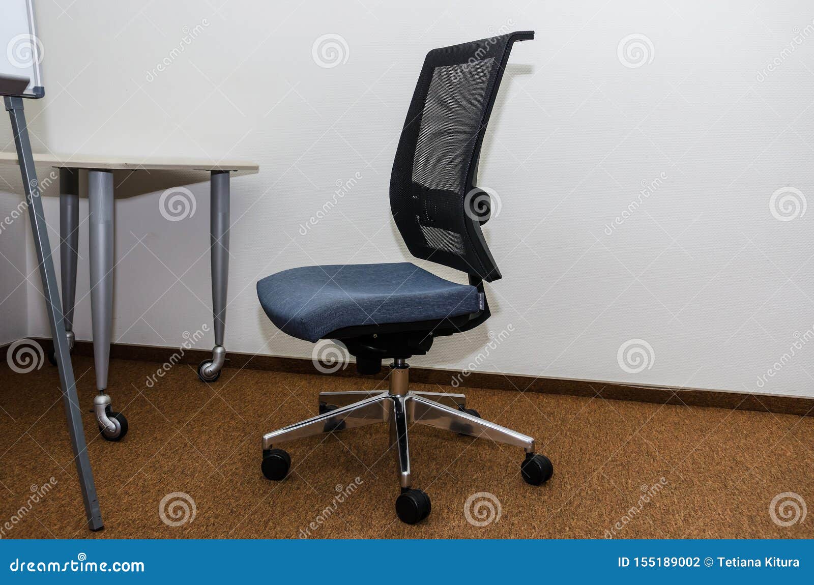 Office Chair Near the Table and Part of a Flipchart Stock Photo Image