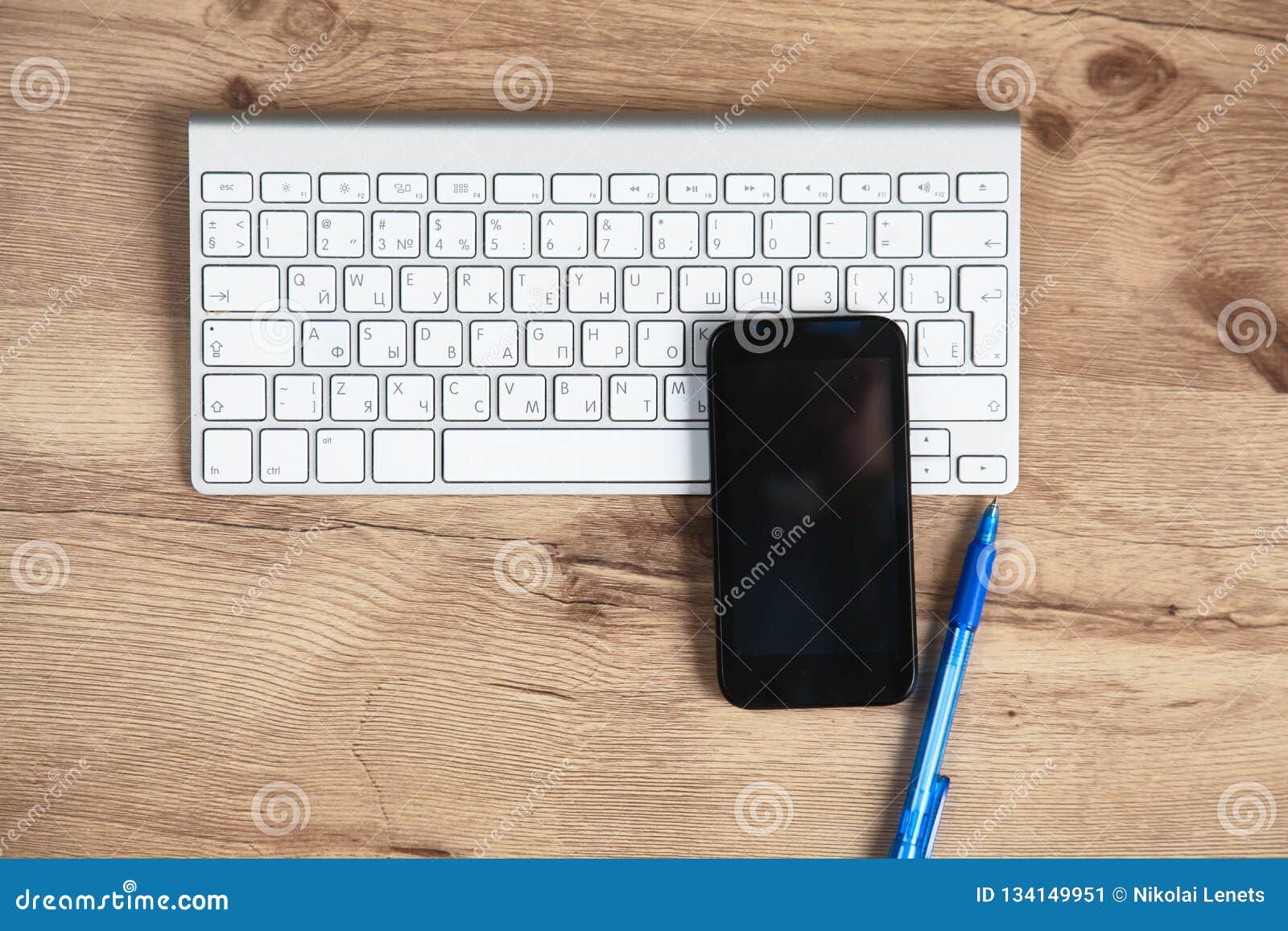 Office Desk with Blank Notebook, Computer Keyboard and Other Office