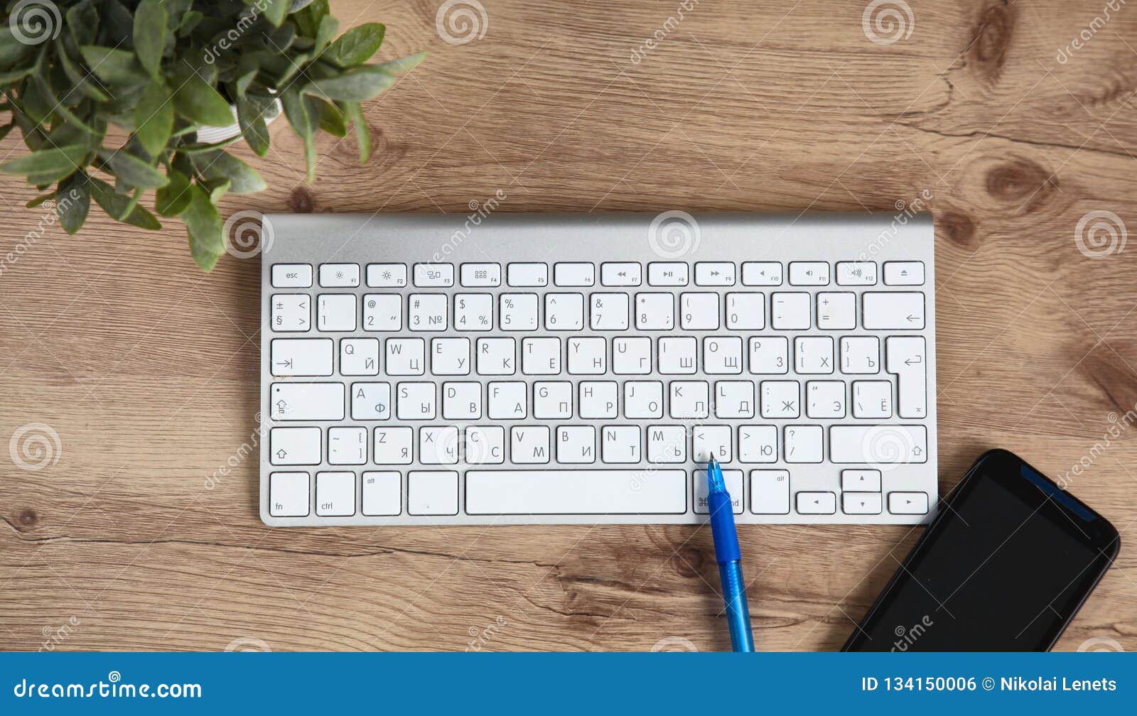 Office Desk with Blank Notebook, Computer Keyboard and Other Office