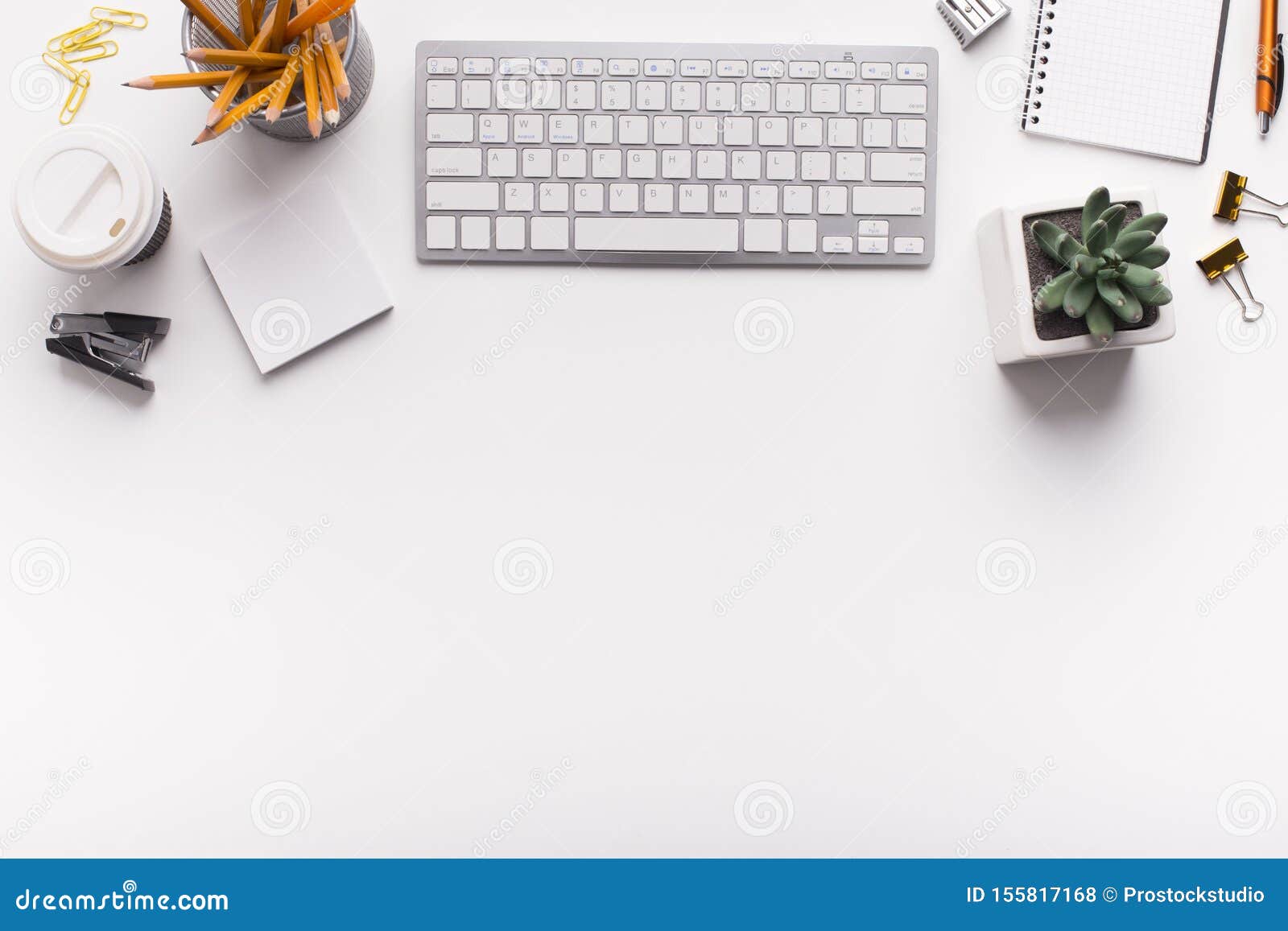 Office Desk with Keyboard and Supplies on White Table Stock Photo