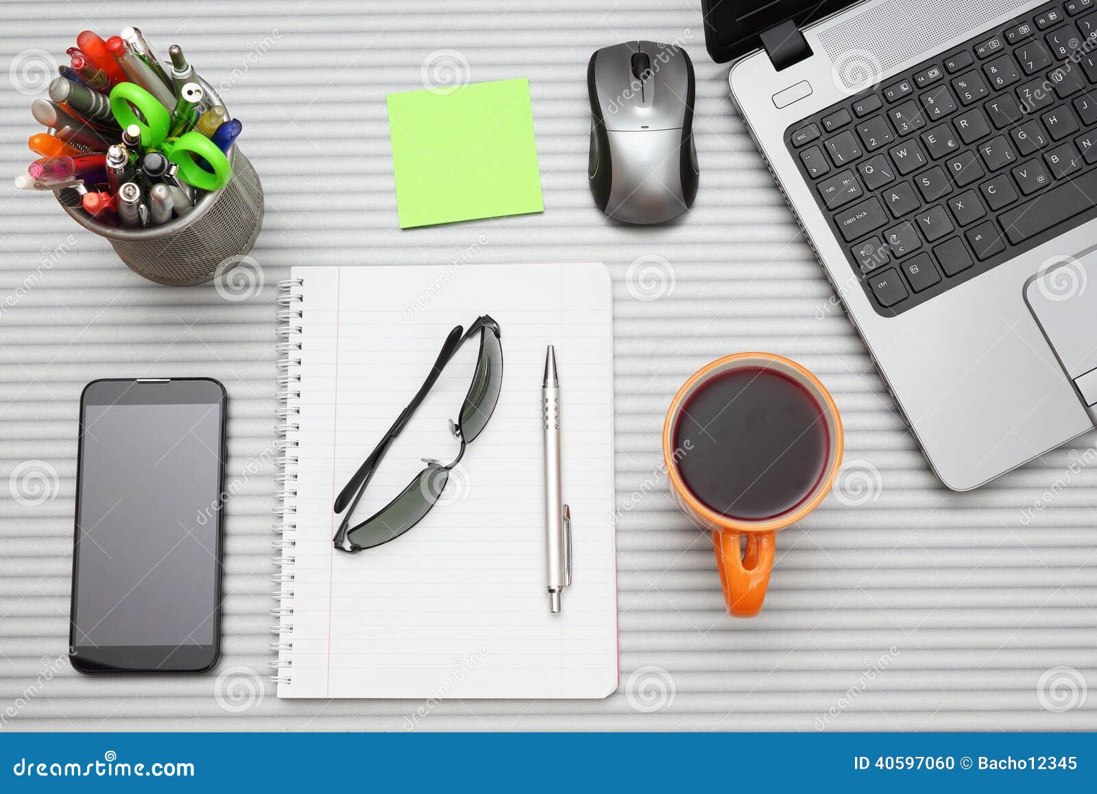 Office Desk with Laptop with Business Accessories and Cup of Tea