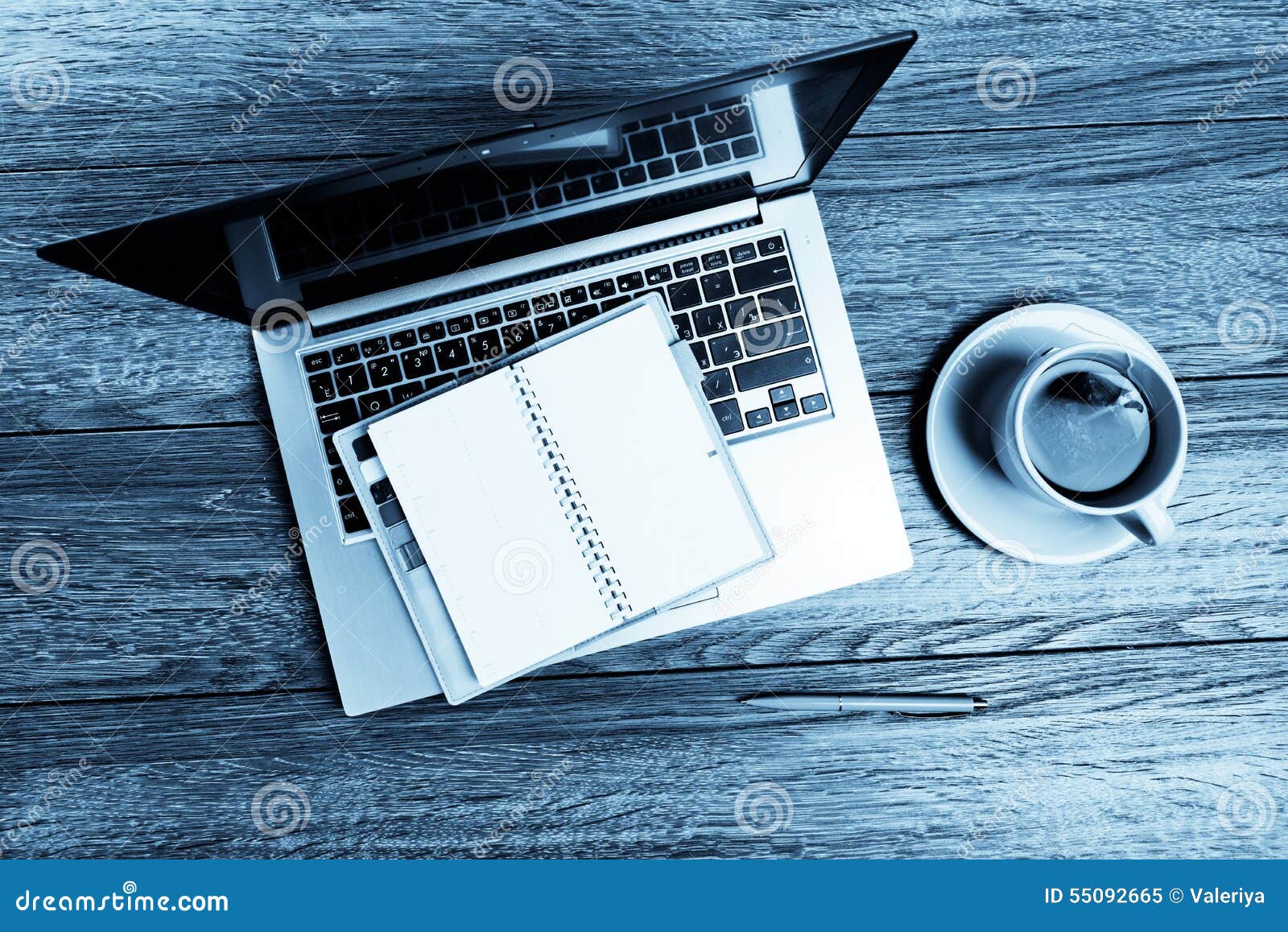 Office Desk with Laptop with Business Accessories and Cup of Tea
