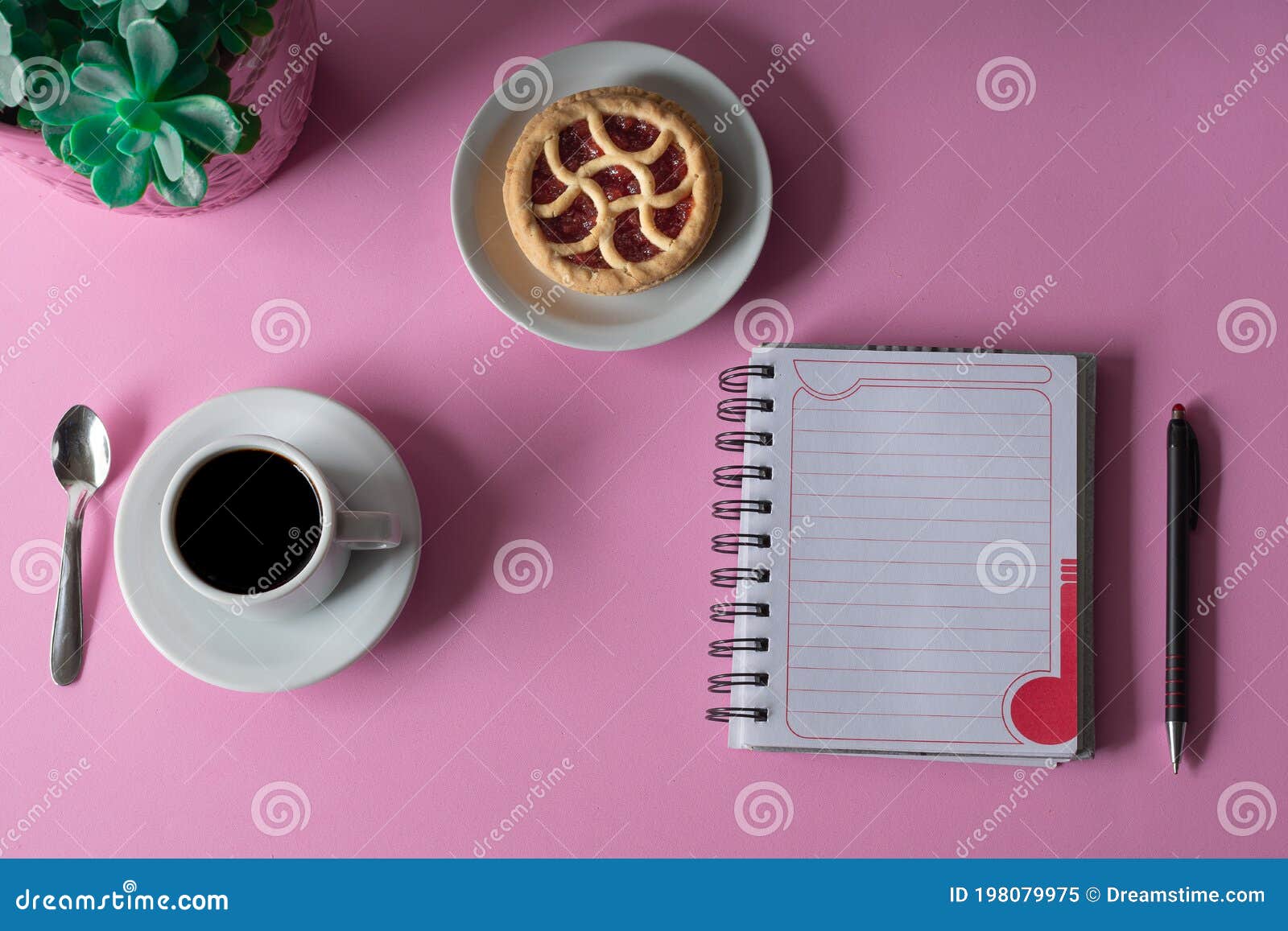 office desk table with notebook and pen and a cup of coffee. top view