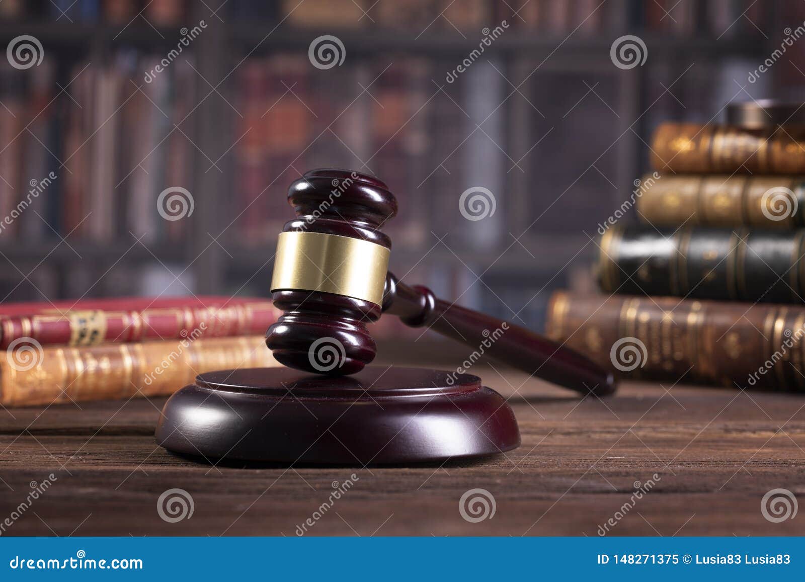 wooden judge`s gavel and law books with treating of laws, legal issues, or cases