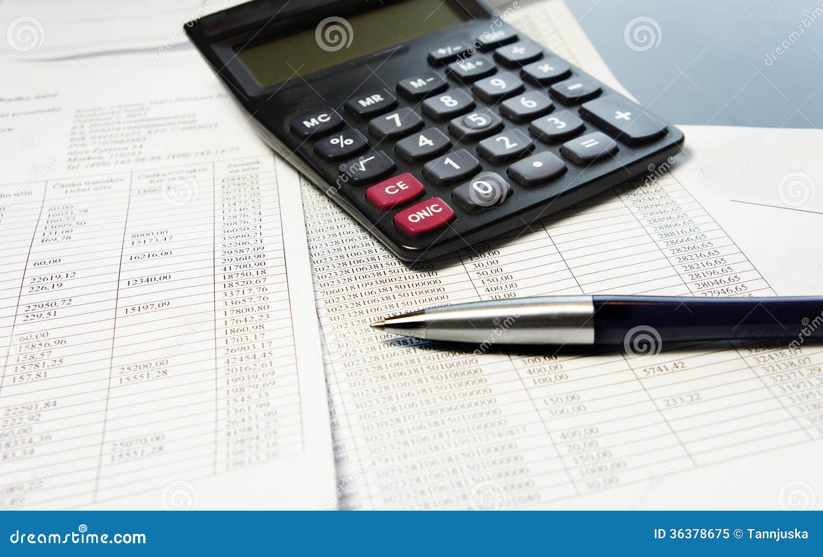 office table with calculator pen and accounting document stock
