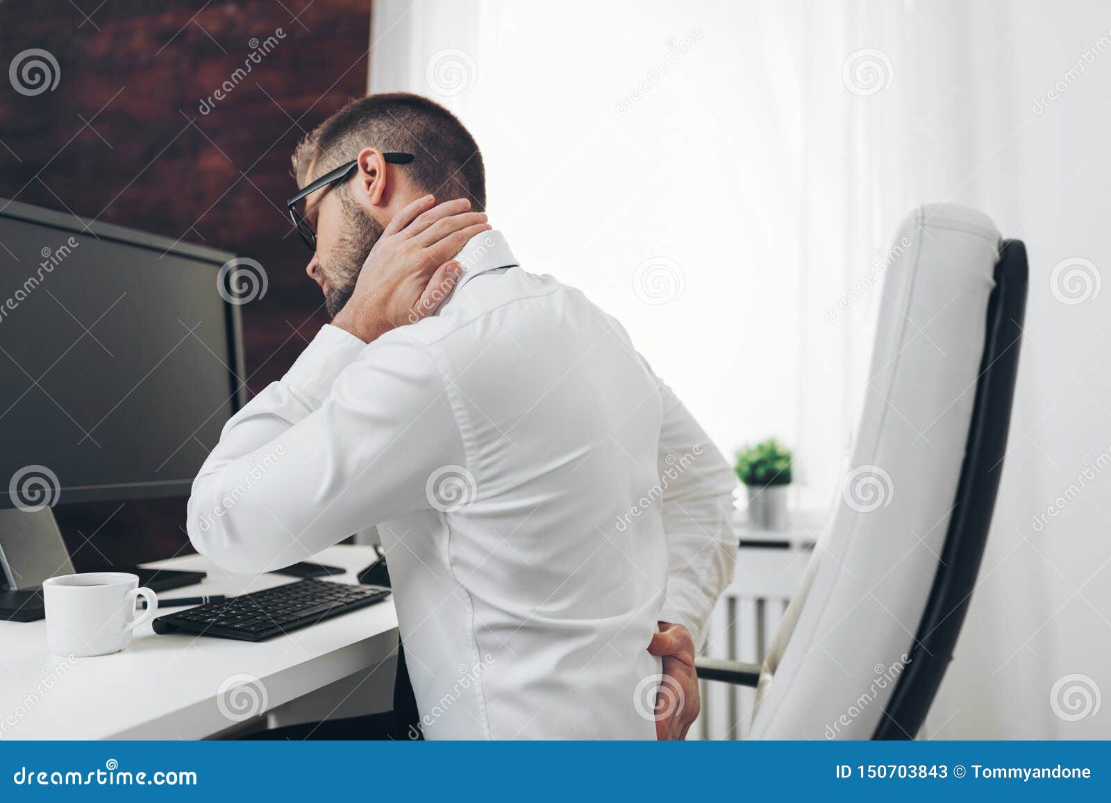 Office Worker With Pain From Sitting At Desk All Day Stock Image