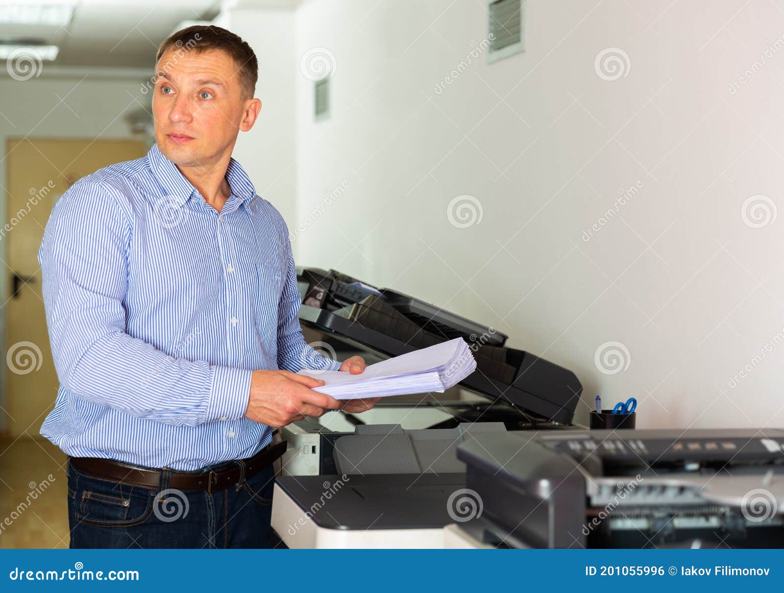 Office Worker Puts a Stack of Paper in the Printer Stock Photo Image