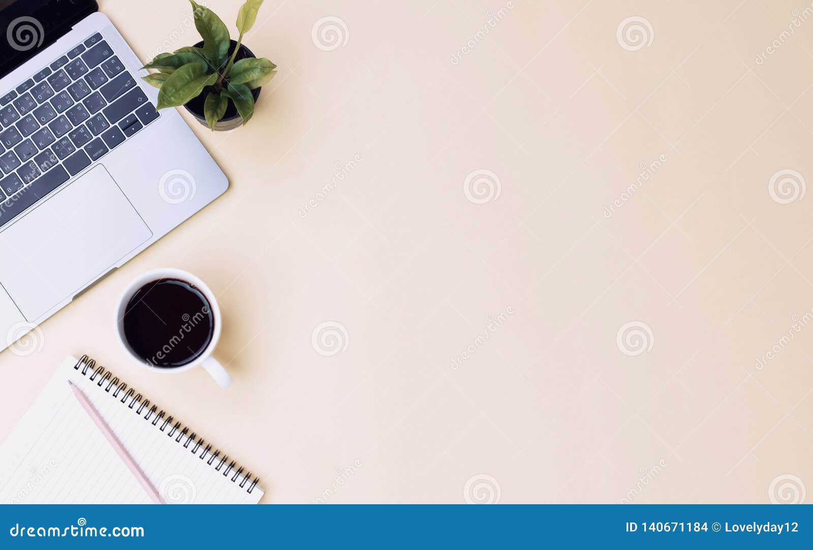 office workspace yellow desk table with laptop, coffee, mobile, notebook, plant