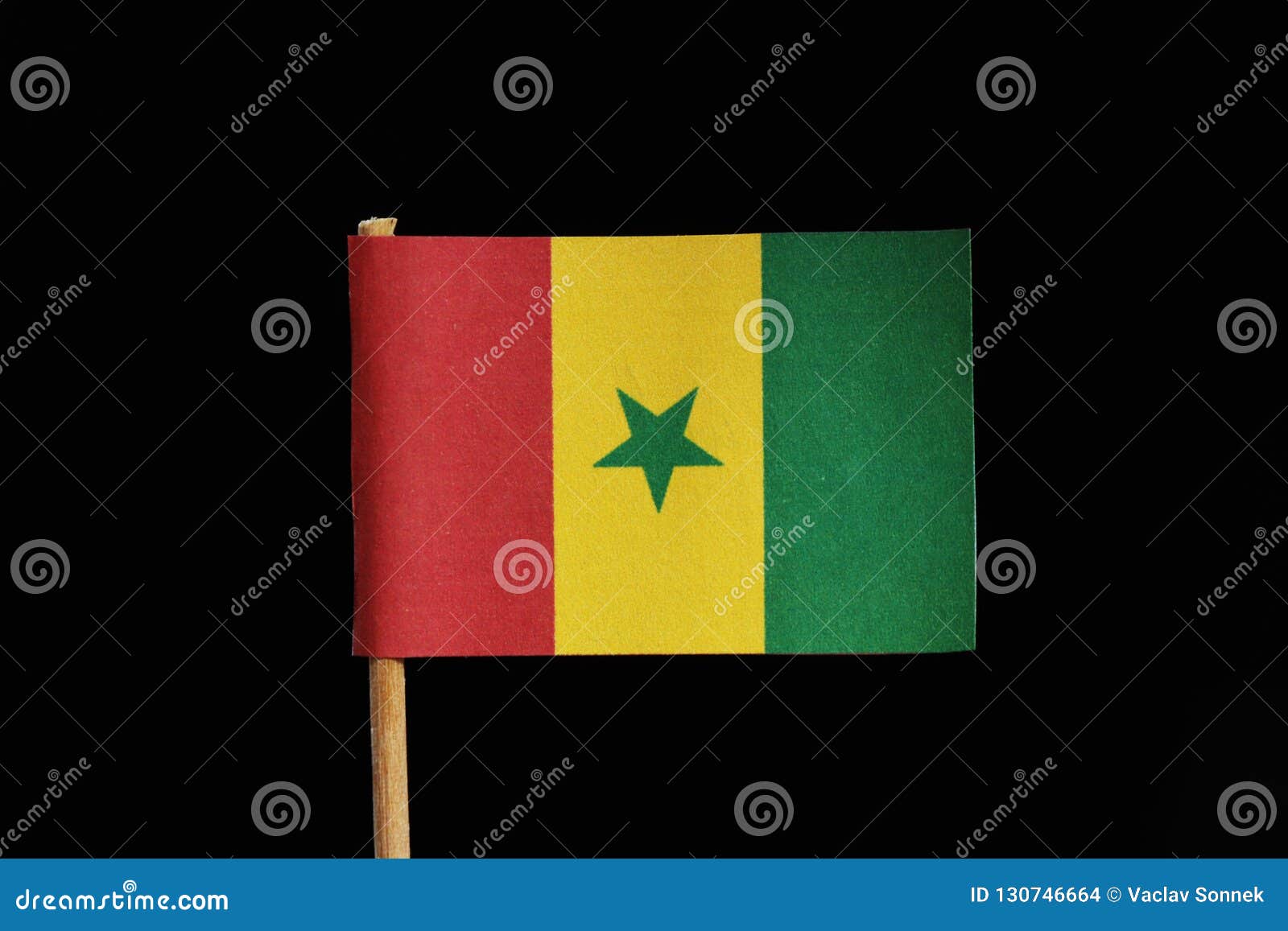 a official and original flag of senegal on toothpick on black background. a vertical tricolour of green yellow and red with green