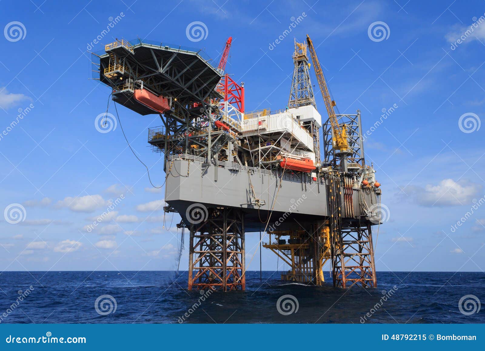 offshore jack up drilling rig over the production platform in th