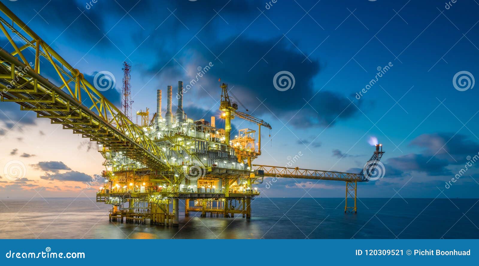 offshore oil and gas central processing platform in sun set where produced raw gases and treat then sent to onshore refinery.